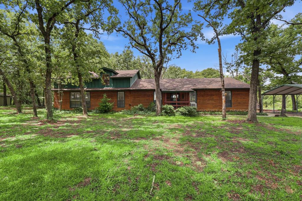 Escape to your own private North Texas retreat! Nestled at the end of a private road and tucked among mature trees, this stunning log cabin style home offers the perfect blend of rustic charm, modern updates, and wide-open space. Situated on 16 fully fenced AG-exempt acres, this property is ideal for horses, livestock, recreation, or simply enjoying the peace and privacy of country living.

The nearly 3,000 square foot home features 3 spacious bedrooms, 4 bathrooms, a dedicated office, abundant storage, and an inviting open concept layout that seamlessly connects the kitchen, dining, and living area. Recent updates include beautiful butcher block countertops, hardwood flooring in the kitchen and dining areas, new carpet in the living room, guest bedroom, and office, along with numerous additional improvements detailed in TransactionDesk.

Step outside and discover everything needed for an equestrian lifestyle. The property boasts a riding pad, loping arena with sandy loam soil, coastal pasture, a large loafing shed, a deep pond, and multiple large pens suitable for horses or cattle. A standalone tack and feed shed on a concrete slab with electricity provides added convenience, while the oversized detached two-car garage offers plenty of room for vehicles, equipment, and recreational toys.

The expansive back porch creates the perfect setting for entertaining, weekend barbecues, or simply enjoying the peace and quiet of the outdoors. A circle driveway offers easy access and ample space for large trucks and horse trailers to turn around as well as other equipment.

Whether you're looking for a working ranch, horse property, weekend getaway, or an adventurous home in the woods, this one-of-a-kind Gainesville property offers the privacy, functionality, and country lifestyle you've been searching for.