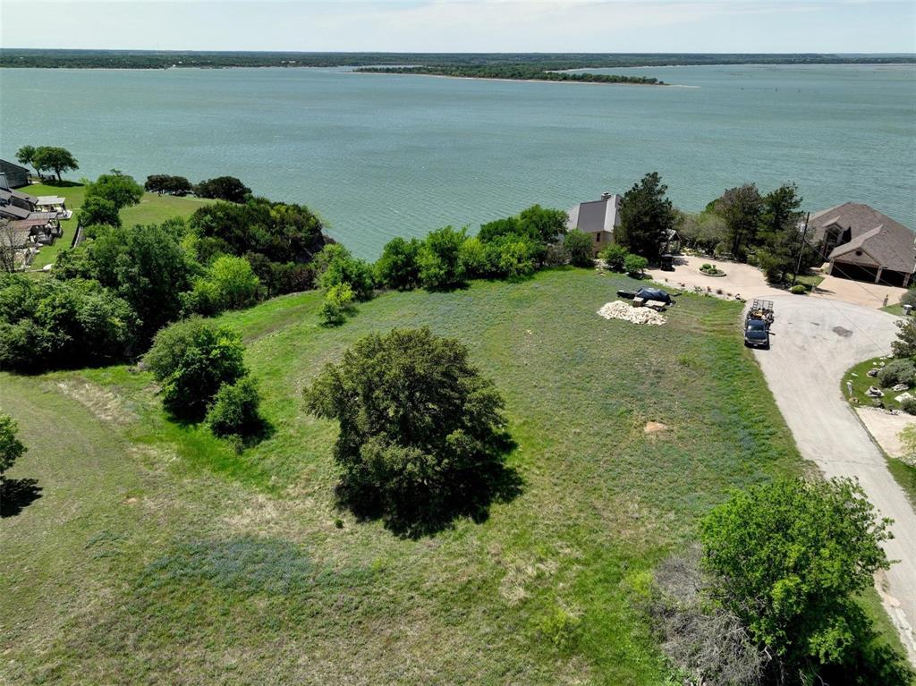Desirable lake front homesite in the resort! This White Bluff lot on Lake Whitney has a unique view, amazing sunsets, lake and bluff views, plus star filled skies. Build your dream home and experience all the perks this resort property has to offer. Full golf membership transfers with sale along with full use of amenities including marina, tennis courts, pickleball courts, 4 pools, two 18 hole championship golf courses, parks, playgrounds and much more. Enjoy country living in this beautiful gated and guarded community. Enjoy the deer, turkey, and wildlife in addition to the peace and serenity that is unique to this community. RV parks and Mulligans Grill are a plus for those that just want to use the amenities. Don’t forget the limestone bluffs, still water coves and uncongested lake traffic.