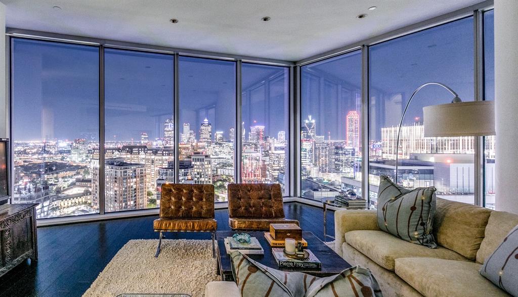 Rare sub-penthouse at the iconic Azure w both sunrise & sunset views as seen through oversized 11ft floor to ceiling windows.This open floor plan smartly displays the Dallas skyline ranging from east of FairPark all the way west to the Virgin Hotel offering breathtaking views. The living area is spacious & well-suited for entertaining w easy access to both of the outdoor living terraces featuring cozy gas fireplaces. The handsome kitchen is well-appointed & conveniently adjacent to the dining area featuring its own fireplace & overlooking the luscious views of the DesignDistrict, Calatrava Brdg, Am Airlines & the vast landscape west. Both bedrms have ensuite bath w full tub, separate shwr, lrg vanity & walk-in closets in addition to access to the separate terraces. Primary bedrm includes a separate fireplace, dual entry doors into the bath area & a custom closet design. Electric shades, two lrg hall closets, full utility rm & oversized 3 car enclosed garage complete this amazing home.