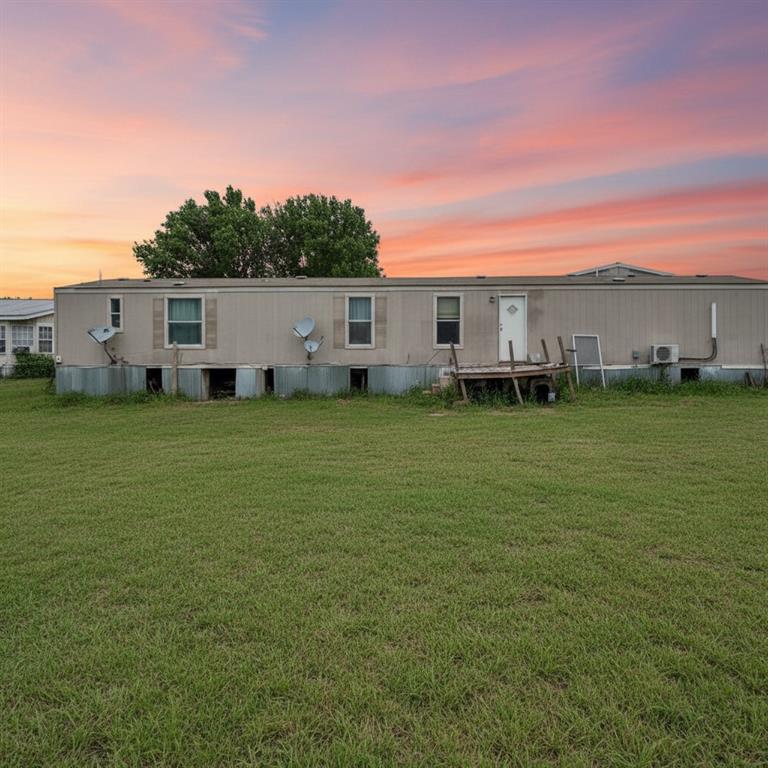 Charming manufactured home situated on over an acre in a peaceful setting with mature trees out front. Enjoy the quiet country feel from the spacious front porch or unwind inside. This 3 bedroom, 2 bathroom home offers a functional layout with plenty of potential for someone looking to add their personal touch. Property is fenced and provides ample space for animals, gardening, or simply enjoying the outdoors. Includes a storage building for added convenience. Barn for your animals. Home does need some TLC and is priced accordingly, making it a great opportunity for an investor, starter home, or someone looking for acreage with upside.
