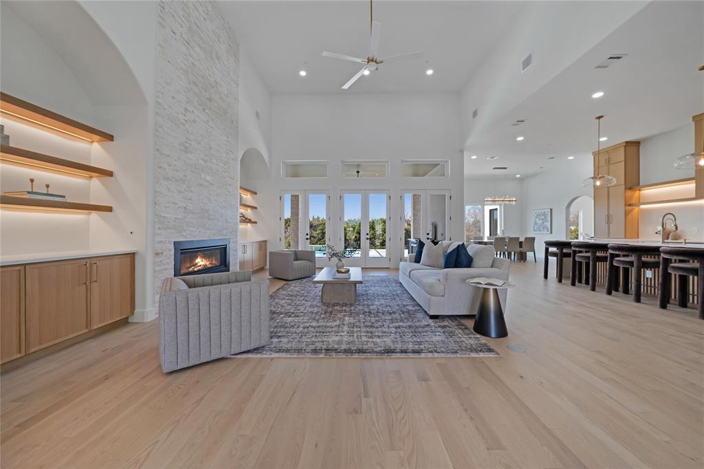 Best-Priced New Construction in Ridge Lakes – Now Under $2M. This completed, exceptional, single-story estate offers 4,808 square feet of thoughtfully designed luxury on an expansive .65-acre lot, blending refined craftsmanship with modern sophistication. Featuring four bedrooms, four and a half baths, and a rare four-car garage, the home is tailored for both elegant entertaining and everyday comfort. Upon entry, soaring 18-foot ceilings in the foyer and great room create a dramatic first impression, complemented by 12-foot ceilings throughout the rest of the home. Natural oak hardwood floors flow seamlessly through the living spaces, while custom white oak cabinetry, Italian tile selections, and Venetian plaster finishes showcase impeccable attention to detail. The gourmet kitchen is a true centerpiece, highlighted by a striking quartz waterfall island and counters, luxury appliances, and designer lighting. Dedicated spaces include a private office, a fitness room or second office, a formal dining room, and a media room complete with a wet bar—perfect for hosting gatherings. The primary suite is a private retreat featuring 13-foot LED tray ceilings, elegant arched vanities, a spa-inspired rain shower, and an expansive dream closet. Designed for modern living, the home is smart-home ready and prewired for whole-home audio, security cameras, and WiFi access points. Outdoor living is equally impressive with a covered patio showcasing an outdoor fireplace and kitchen, all overlooking a custom pool with a tranquil waterfall feature—an ideal setting for relaxation or entertaining year-round. $25,000 builder credit when using preferred lender. Rates as low as 4.99%.