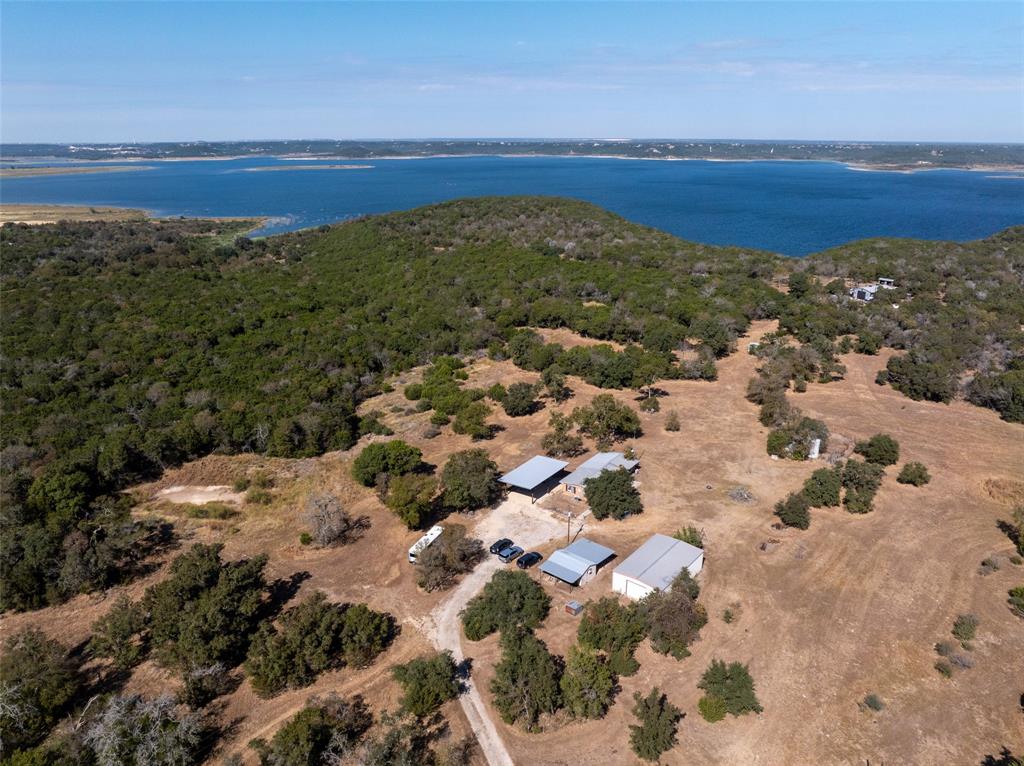 Secluded at Salado's western edge, this lakeside property is a hunting, fishing and ranching paradise. Overlooking the shimmering waters of Stillhouse Hollow Lake, this extraordinary 34-acre property is far more than a home, it is a rare and storied piece of Texas heritage. Built in the 1960s and overlooking what was once the Lampasas River, this land carries the legacy of the historic Chisholm Trail, where cattle drives once carved their path through the heart of the state.
The rustic 2-bedroom, 1-bath residence, used as a weekend getaway and cattle ranch, offers a quiet, unassuming retreat, allowing the land itself to take center stage. From its vantage point, the property captures sweeping views of the lake, now a premier fishing destination, while preserving the sense of seclusion and privacy that makes it feel worlds away.
What makes this offering truly exceptional is its provenance. This acreage sits on what was once the original road descending to the river along the Chisholm Trail, placing you in direct connection with one of the most iconic chapters of Texas history. Opportunities to own land with this level of historical significance, natural beauty, and uninterrupted acreage are exceedingly rare.
The cattle still graze. The deer and turkey still play on this agricultural exempt and fenced land. The land fans out as it backs to Stillhouse Hollow Lake, affording direct access to more than 2,000 acres of public shoreline to explore. Renowned for its clear waters and fabulous fishing, the Army Corps of Engineers-managed lake is your neighbor and your imagination is your only limit. Salado's historic Main Street and golf course are minutes away.
Whether you envision a private escape, a legacy ranch, or an investment in a one-of-a-kind setting, this property stands as a trophy holding, where history, landscape, and solitude converge.
Own a piece of the trail. Own a piece of Texas.