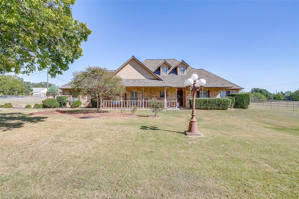 Country living close to the city. Custom 3 bedroom, 2 bath home on 2 acres in Joshua ISD. Come watch the sunsets from the cozy front porch or the back patio. Plantation shutters and crown molding. Family room with woodturning fireplace, open to a formal dining room or a second living area. Kitchen with quartz countertops, breakfast bar, stainless appliances, oven with warming drawer, glass cooktop and a window over the sink overlooking the front porch. Large primary suite with en-suite with garden tub and large separate walk-in shower and two walk-in closets. Large secondary bedrooms. Enclosed patio-sun room runs along the back of the house, overlooking the property. Backyard with entertaining area with grilling area and outdoor fire pit. Workshop with electricity with work benches and many storage areas. Fenced for your animals. Long concrete driveway to a 2 car side entry garage and a double gate that leads to the workshop. Immaculate home, just needs your personal touches.