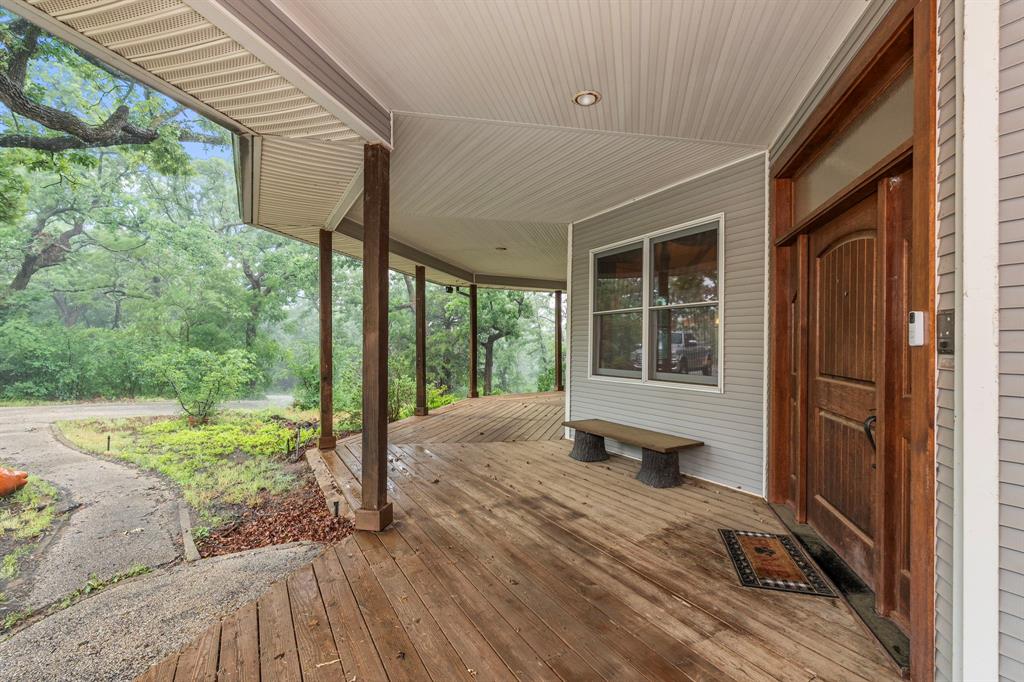 This extraordinary home, situated on 4.6 acres boasts a 5000 SF metal shop, and may be one of the most unique properties in Denton County.  Beautiful custom built 1990 home, pier and beam construction, and sits high on a hill overlooking the Denton skyline. Perfect property for someone needing a large shop for their business and-or hobbies.  Spacious rooms, abundant windows and tons of storage throughout. Multiple living areas and large fenced back yard for pets.  4968 SF of air conditioned living space, but with the 10 foot covered porches wrapping the house it adds up to be approximately 6933 SF under roof.  Huge living room with built-in entertainment center for TV.  Wood burning fireplace with heat exchanger designed to heat the entire home.  Large wet bar with overhead wine bar, fridge and concrete counter tops.  Gigantic octagon shaped game room wrapped in picture frame paneling and wall of windows, is currently used as an office but originally designed as a billiard room. Large master bedroom with fireplace and its own attached deck and sunroom with amazing views.  Master bath features a two person sunken jetted tub, walk in shower with double shower heads, and huge walk-in master closet.  Recently remodeled kitchen features a commercial Viking Range, Sub Zero Fridge and concrete countertops.  Deep water well feeds the house, oversized 3 car garage, 12x14 storage shed and roof replaced Nov 2024.
The home is currently laid out as a 3 bedroom floorplan, but offers flex rooms that could potentially be converted to create a 4th bedroom.
