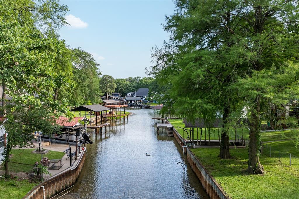 This beautifully updated, charming home is a rare find—situated on two lots in a quiet waterfront channel, making it the only property of its kind in the neighborhood. The home features 3 spacious bedrooms with walk-in closets, 2 bathrooms, and a 2-car garage. Inside, you’ll find a bright, oversized living room with fresh white paint, along with an open-concept kitchen and dining area complete with a breakfast bar—perfect for everyday living and entertaining. Step outside to enjoy peaceful waterfront living. The backyard offers a covered patio and a newly built deck (2022), ideal for relaxing with your morning coffee. The property also includes a new roof installed in December 2021. Additional highlights include a detached guest house that can easily serve as a home office or gym, an above-ground pool with a deck and pergola (built in 2022), a storage building 10x6, boathouse with boat lift, and a private fishing pier. The trampoline and children’s play set will convey with the property. With its unique double-lot setting, versatile spaces, and waterfront amenities, this home truly has everything your family needs—and more.