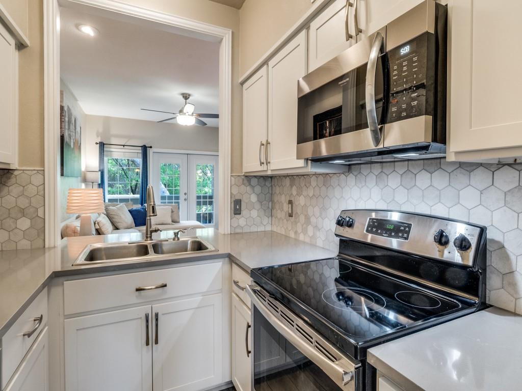 Priced to sell! Location, value, and convenience come together in this move-in ready townhome-style condo located on the second floor in the heart of the Lake Highlands area. This 2 bedroom, 2.5 bath home places you just minutes from premier shopping, dining, and entertainment.  Step into a bright, open living space featuring luxury vinyl plank flooring and abundant natural light. Double doors lead to a private balcony with peaceful treetop views—perfect for relaxing. The kitchen showcases quartz countertops, plenty of cabinets, and a decorative tile backsplash. The spacious primary suite offers beautiful tree-lined views and double closets, while the secondary bedroom includes its own private exterior entrance—ideal for added flexibility.  Enjoy being just steps from the community pool and minutes from I-635, NorthPark Center, and Lake Highlands Town Center. Both HVAC units were recently replaced. HOA includes water, sewer, and trash. Experience East Dallas convenience with a welcoming neighborhood feel in a highly desirable location.