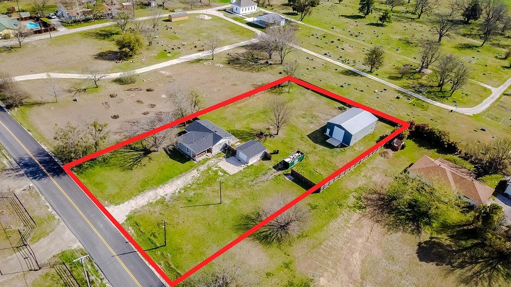 1 Acre Lot includes a Cozy, Bright and inviting 3-bedroom or 2 Bedroom plus an office, 2 Bath Home with Charming covered front Porch, which adds to the excitement of pulling up to your new home, inviting guests over for a relaxing evening or movie night. or ideal for watching the sun set.    Added in 2025,  A Massive 1476 Square Foot Workshop with Electric, 14 foot A-frame ceiling featuring two bay doors. Will accommodate an automotive lift, heavy equipment and more.  Also in 2024,  Updates and Upgrades to the home include:   Roof,   Foundation,   Drainage,   Hot Water Heater,   Solar Powered fan for the Attic, to improve the functionality of the insulation and is said to lower utility expenses.   Other upgrades include:  Windows,   Paint,   Flooring,   Siding,   and Appliances.   You've just found the perfect home and perfect workshop for all of your projects.  Property also features an Additional detached oversized 1 car Garage, Fenced yard with room to build,   Plenty of Room for Boat or RV Parking.
