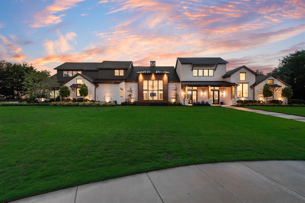 This stunning Hill Country Modern home is nestled within a private culdesac surrounded by lush green belts offering gorgeous sunset views.  This luxurious property offers a resort style custom pool and spa which features elegant water elements, sunning decks and firebowls, perfect for relaxing and entertaining.  The multiple outdoor living spaces include an outdoor grilling dining area and a cozy firepit, creating the ultimate retreat.  Inside you'll find an expansive open concept with natural hardwood flooring and decorative wood beams accentuated by designer lighting and ceiling fans throughout. The living room centers around a dramatic floor to ceiling marble clad fireplace that seamlessly flows into the chefs kitchen featuring a built-in referigerator and freezer, a 6 burner gas stove with griddle, warming drawer, microwave drawer, soft close cabinetry, custom pantry system and Butlers prep pantry.  The dining room showcases a built-in wine cellar wall with wine fridge.  The luxurious primary suite offers a vaulted exposed wood beam ceiling and a spa like bathroom with a standalone soaking tub, designer mirrors, a wall of custom linen and personal storage, His and Her custom closets and a hidden safe room.  The media and gameroom both offer hand crafted cabinetry with beverage fridge.  The well appointed laundry room features beautiful cabinetry for upper and lower storage,  folding counter tops, a wet sink, space for 2 washers and dryers plus a built-in refrigerator.  All auxillary bedrooms include en suite customized bathrooms.   The 4 car oversized garage has epoxy flooring, work out or workshop area, an EV charging port and heavy duty steel wall mounted storage.  Through the walls of windows and atrium doors you can enjoy the serenity of the outdoor sanctuary from most every room.