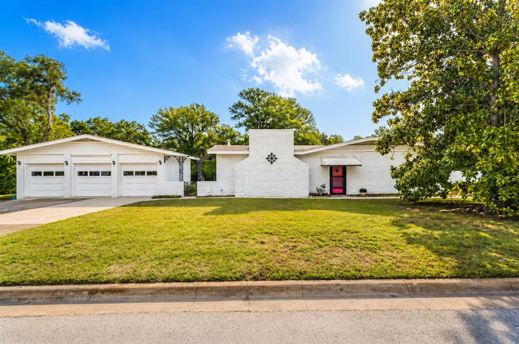 Rare Mid-Century Modern Gem on Half an Acre in Lakeside! Short distance from Lake Worth, Fort Worth Nature Center, Fort Worth Stockyards and Downtown Fort Worth. Major employers nearby include Lockheed Martin, Naval Air Station JRB, and BNSF. This beautifully maintained mid-century modern home is full of character, charm, and timeless design. Situated on a spacious half-acre lot, this unique property offers the perfect blend of original features and outdoor escape. Step outside and enjoy the open yet private lot lined with trees and mature landscapes. Inside, you’ll find 3 bedrooms and expansive living spaces, including both a large living room and an oversized den — ideal for entertaining or relaxing. The den is a true standout, featuring rich floor-to-ceiling wood paneling, a striking wood beam ceiling, and a large fireplace that creates a warm and inviting atmosphere. Original house details include beautiful wood flooring and distinctive brick accent walls, preserving the home’s authentic mid-century appeal. The kitchen offers ample cabinet and countertop space and features its original electric range, adding to the home’s character. Additional highlights include a full-size laundry room conveniently located off the den and an oversized 3-car garage, providing plenty of space for vehicles, storage, or hobbies. Major updates bring peace of mind, including a NEW ROOF in 2021 (on both the home and detached garage), a NEW HVAC system installed in 2024, and a NEW ELECTRICAL PANEL AND BOX installed in 2025. Azle ISD. This property is truly a rare find — and even offers the opportunity to purchase the adjacent lot for added space or future possibilities. Don’t miss your chance to own this one-of-a-kind property. BRING US AN OFFER!