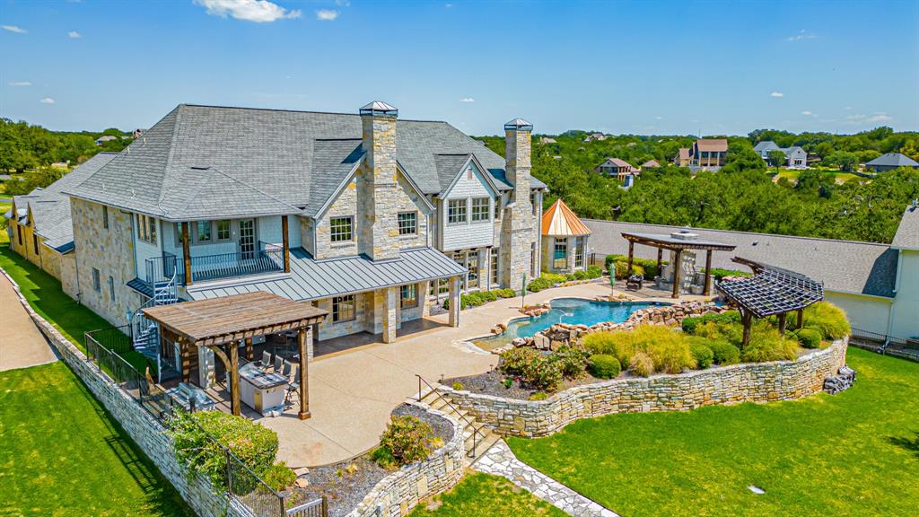 Fabulous mainbody Lake Granbury, master piece, custom home built by Chris Thomas.  This property has it ALL!  Phenomenal views for miles down both directions of the lake, boat house for boat and 2 jet skis, tram and stairs to the water,  salt water pool with fountains and grotto, outdoor fireplace, spa, beach entrance and swim in place current area, outdoor kitchen with double grills, gameroom with kitchenette, media room, elevator, BOWLING alley, exercise room, safe room, 6 bedrooms, all with private baths, gorgeous study with fireplace and built ins.  The primary bedroom has sitting area with lake view, hugh ensuite bath with dual vanities and dual master closets.  This home has quality craftsmanship throughout! There is a huge attic for storage up easy access steps off exercise room. The HVAC is geothermal to maximize heating and cooling efficiency.  It is truly a MUST if you are looking for the BEST that Granbury has to offer.