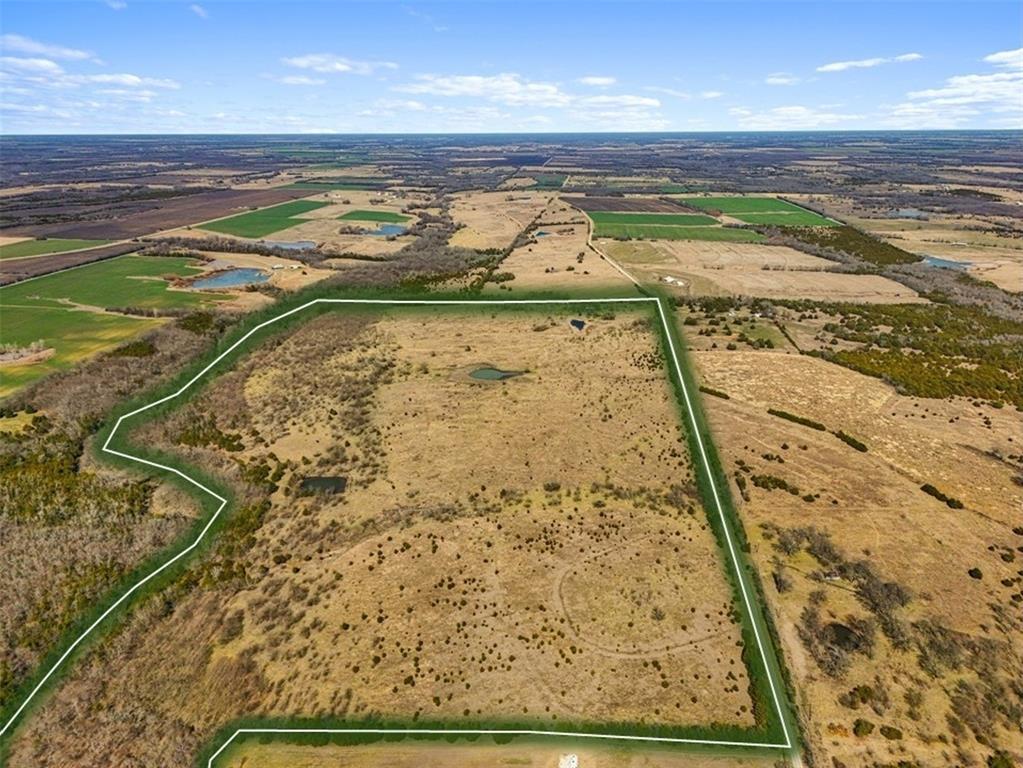 Discover the possibilities with approximately 142 acres in Lamar County offering a rare blend of open space, functionality, and freedom. Currently used for agricultural purposes and carrying an Ag exemption, this expansive property is well suited for ranching, livestock, recreation, or building the custom home you have always envisioned. With no building restrictions and no HOA, you have the flexibility to create a homestead tailored to your needs.
The land is fenced and thoughtfully equipped with three ponds, a livestock structure, and a working pen, making it ready for continued agricultural use. With approximately 3200 feet of road frontage, access is convenient and offers potential for future division or multiple entry points if desired. Water and electricity are available at the county road, adding to the property’s versatility and development potential. Whether you are looking to expand your operation, invest in Texas land, or build your dream home surrounded by wide open skies, this Lamar County acreage is an exceptional opportunity.