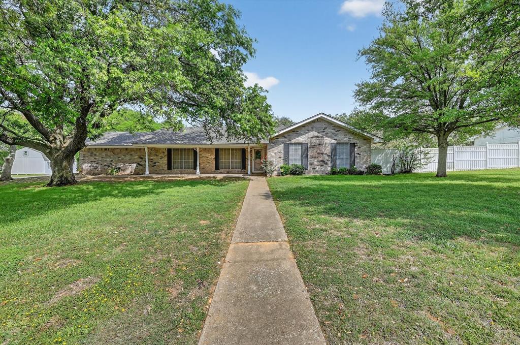 Enjoy the best of both worlds-peaceful country living with convenience of being 45 minutes away from DFW International Airport! Ideally situated just minutes from top-rated schools, shopping, dining, & quick access to the Chisholm Trail, this spacious 4-bedroom home offers 2,819 square feet designed for comfort, flexibility, & entertaining. From the moment you step inside, you’re welcomed by a warm & inviting living area anchored by a stunning stone wood-burning fireplace—perfect for cozy evenings at home. The open flow between the living, dining, & kitchen spaces creates an ideal layout for both everyday living & hosting gatherings. Kitchen offers ample cabinetry, generous counter space, & easy access to the formal dining room, where you’ll have plenty of room to host holidays & special occasions in style. A dedicated office provides the perfect work-from-home setup and with high speed internet available offers space to do business or easily serve as a fifth bedroom if needed. Second living area adds even more flexibility—ideal for media room, playroom, or quiet reading retreat. The private primary suite is thoughtfully positioned & features an ensuite bath designed for relaxation, while two additional bedrooms on the same side of the home offer comfort and convenience for family or guests. A bonus room just off the main living area provides endless possibilities—whether you need a hobby space, gym, or additional lounge area. Step outside and enjoy the wide-open space & functionality this property provides. In addition to the 3-car garage, you’ll find two spacious storage buildings perfect for tools, equipment, or hobbies. The property is also equipped for RV parking with a covered carport, 50-amp service, & sewage pump—ideal for travelers or guests. With room to roam, space to entertain, and a location that keeps you close to everything, this property truly offers the best of both worlds. Don’t miss your chance to own this versatile and beautifully appointed home!