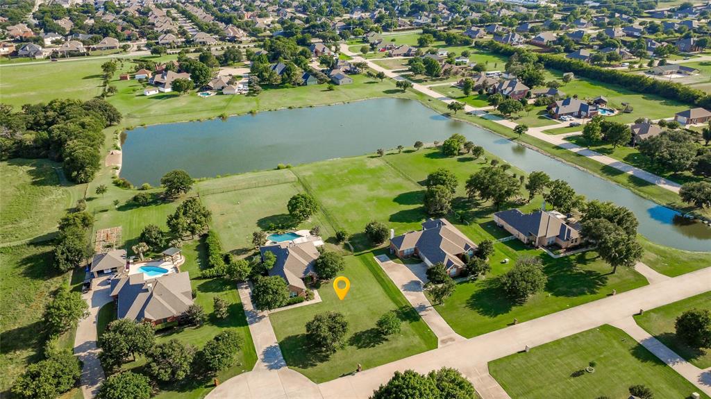 Welcome to 104 Island Circle, a truly exceptional estate nestled on a breathtaking one-acre waterfront lot in the highly sought-after gated community of Lakes of Shady Shores. Backing directly to one of the neighborhood’s scenic ponds, this property offers stunning water views and abundant wildlife in a peaceful and picturesque setting. The pond is fully stocked for private resident fishing, allowing you to cast a line right from your own backyard and enjoy a truly unique waterfront lifestyle. Surrounded by protected land on all sides, the incredible views will never be obstructed, providing lasting privacy and tranquility. The front of the home enjoys beautiful horse pasture views, while the property sits adjacent to the prestigious Hidden Valley private neighborhood and airfield. The beautifully updated home features an open-concept layout with the kitchen flowing seamlessly into the spacious living area, a private office, formal dining space, game room, split-bedroom design, and a luxurious primary suite with French doors leading directly to the backyard retreat. Step outside to an incredible resort-style oasis complete with a custom gunite pool and spa, expansive flagstone patios, multiple covered sitting and entertaining areas, a pergola, and over 1,000 square feet of outdoor living space. Beautiful magnolia trees and dedicated garden bed areas enhance the serene setting, while the massive backyard provides endless possibilities for recreation, entertaining, gardening, fishing, or simply enjoying the tranquility of your own private estate. With its unmatched one-acre lot, forever-protected views, exceptional outdoor amenities, and secure gated setting, this is a rare opportunity to own one of the most desirable properties in Lakes of Shady Shores.
