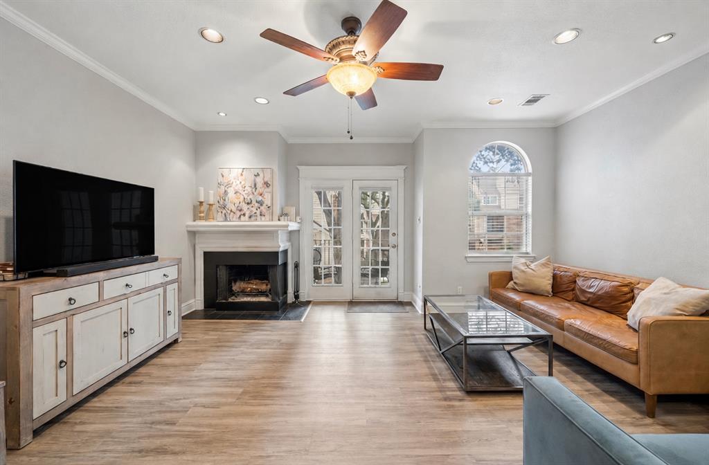 Beautifully updated two-story condo offering privacy, flexible living space, and two separate entrances, all centered around a charming atrium setting. Rich architectural details, including crown molding, decorative millwork, and a beautifully framed dining room entry, create timeless character throughout the home. The main level features a spacious living area with a cozy wood-burning fireplace, a dedicated dining space, and an open kitchen complete with built-in cabinetry and a wine rack. Large windows fill the home with natural light, while the living room opens to a covered balcony overlooking the community pool—perfect for relaxing or entertaining. The balcony also includes a convenient storage closet. A half bath completes the first floor. Upstairs, accessible via the interior staircase or a second private entrance, are two bright en-suite bedrooms separated by a centrally located laundry room with a side-by-side washer and dryer. The primary suite serves as a true retreat, featuring its own wood-burning fireplace, walk-in closets, and a comfortable sitting area. Recent updates include newly installed flooring and designer paint throughout, making this home truly move-in ready. The refrigerator, washer, dryer, and elegant staircase mirror will convey with the sale. Ideally located within walking distance of the shops, restaurants, and entertainment along Addison’s vibrant Belt Line Road corridor and just minutes from Addison Circle, this home also offers convenient access to the DART Silver Line, providing direct service to Dallas-Fort Worth International Airport. Enjoy low-maintenance living in one of Addison’s most desirable and walkable locations.
