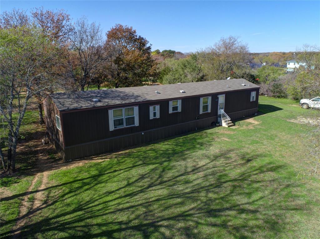 2 Acre mobile home property with AG exemption in sought after Mansfield ISD. This property is nestled in a quiet Cul De Sac with plenty of room for your animals to roam. Beautiful eat in kitchen and open living space that seperate the primary bedroom with ensuite from the additional two bedrooms and bath. Large covered deck attached out back. This home is outside of city limits with a more favorable tax rate. No HOA and all the freedom you could want within close proximity to shopping, restaurants, and major highways. Please note sellers have cats and dogs that reside in the home and they are smokers as well. They will allow a concession for new carpet and paint throughout with the right offer. Cash or Conventional Buyers Only due to property being in a flood zone. No history of flooding.