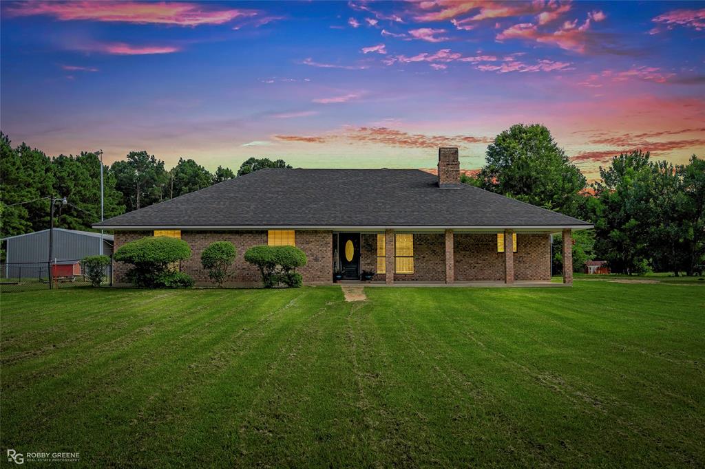 Welcome to peaceful country living! Situated on 11.40 beautiful acres in Doyline, this refreshed 3-bedroom, 2-bath brick home offers approximately 2,100 heated square feet of comfortable living space with room to spread out both inside and out.

Recent updates include new flooring throughout, fresh interior paint, and updated light fixtures in select rooms, making this home move-in ready for its next owner. The spacious living room features a soaring cathedral ceiling and a cozy wood-burning fireplace, creating a warm and inviting gathering space. The kitchen is open to the dining area, making entertaining easy, while the oversized utility room provides excellent functionality with direct access to the primary suite.

Outside, the property truly shines. The 11.40 acres offer a wonderful mix of open pasture and wooded acreage, giving you the best of both worlds. Enjoy plenty of open space for gardening, farming, livestock, or simply taking in the peaceful surroundings, while the wooded areas provide opportunities for hunting, exploring, wildlife watching, and other outdoor recreation. Additional features include a covered front porch, chain-link fenced backyard, storage shed, stall barn, and RV parking with a concrete slab.

Whether you're looking for a hobby farm, a recreational retreat, or simply a quiet place to call home, this property offers the space, privacy, and versatility to fit your lifestyle.