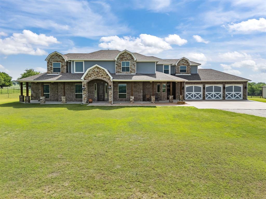 This Aledo residence offers the perfect blend of privacy, space, and timeless Texas appeal. Built in 2012 and set on a generous 13 acre homesite with a gorgeous winding tree lined road to the home. The expansive front porch is defined by a classic brick architecture and gives a peaceful sense of openness that defines Parker County living. Inside, the layout unfolds with comfortable elegance. Multiple living and dining areas create natural gathering spaces for everyday life, celebrations, and quiet evenings at home. Large windows invite soft natural light throughout the day, giving each room a warm, inviting feel. The private owner’s suite provides a quiet retreat, while additional bedrooms and baths offer flexibility for family, guests, and entertaining. There is a room for every family activity including, office, media room, game room and an exercise room. For the large families needing 5 bedrooms, this home is for you.
The heart of the home flows easily into the outdoors, where wide-open land becomes part of the experience. With ample space for a future pool and outdoor kitchen. 
Located within acclaimed Aledo ISD and minutes from I-20, the property provides quick access to Aledo, Weatherford, and Fort Worth—while still preserving the quiet country charm that makes Kelly Road so sought after. Just minutes from the upcoming Bluejack Ranch Golf Course—a world-class destination brought to life by Tiger Woods and designed to be a hub for golf, tennis, pickleball, and high-end social events—this property stands in the path of progress, perfectly poised for both personal enjoyment and future value. With rolling pastures, panoramic hilltop vistas
There is no HOA, offering added freedom and flexibility. The workshop is quality built and ready for any business. Measuring 40 x 75 totaling 3,000 square feet, 12 foot side walls, two 10 foot rollup doors, concrete slab, lights, and electric outlets. This property is the perfect setup for country living.
