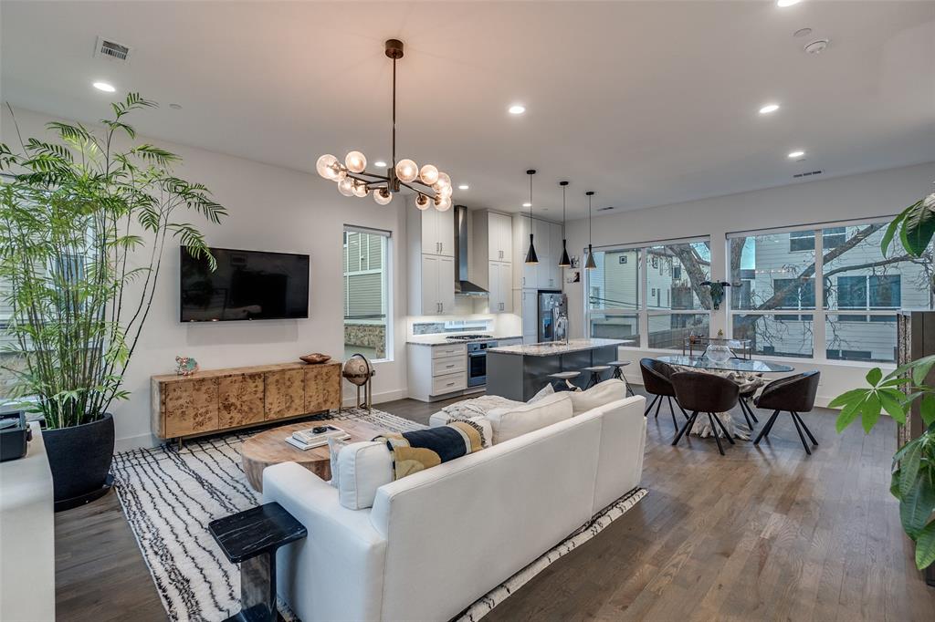 Sophisticated modern townhome ideally located within walking distance to Greenville Avenue’s most popular restaurants, bars, coffee shops, and boutiques. This beautifully maintained residence has been thoughtfully reimagined and enhanced with over $20K in upgrades, offering an exceptional living experience. Soaring 11–14 ft ceilings and massive windows flood the open-concept living spaces with abundant natural light.
Step outside to a reimagined, landscaped backyard patio, creating a private outdoor oasis ideal for relaxing or hosting guests. This exceptional townhome combines prime location, modern elegance, and quality upgrades—an East Dallas must-see.