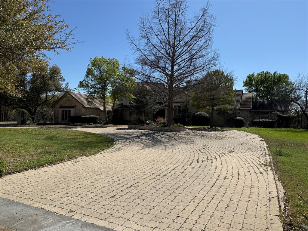 Hilltop estate on over 2 acres in the gated Estates on Rush Creek with panoramic views. This thoughtfully designed home features a chef’s kitchen with high-end appliances, ample prep space, and both casual and formal dining areas. The main living area offers soaring ceilings with exposed wood beams and a beautiful stone fireplace. The primary suite includes an oversized bedroom, large, oversized closets, and a spa-like bath with heated floors, built-in coffee bar, private seclude courtyard with outdoor rain shower. Two private offices provide an ideal work-from-home setup.
The finished walk-out basement includes a full kitchen, huge living area with fireplace, bedroom, and bath, offering flexibility for guests or multi-generational living. This area has views of the pool spa and lush backyard. Additional bedrooms upstairs with multiple full and half baths provide plenty of space for family and guests.
The backyard features lush landscaping, a pool with attached spa, and a cabana with half bath, creating a private outdoor retreat. Additional highlights include an elevator, tornado shelter, and stone wall surrounding the property. This is truly a one-of-a-kind unique resort style property that you cannot miss out on! 

Conveniently located near Fort Worth, DFW Airport, and Dallas.