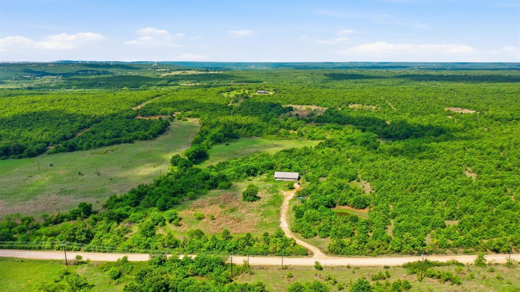 Escape to the quiet countryside at 3180 Rock Creek Road in Jacksboro! This scenic property offers beautiful rolling terrain, wide-open views, and a peaceful setting surrounded by mature hardwoods. Featuring a private pond, open pasture areas, and a home with an extended driveway set back from the road, this land is ideal for a weekend retreat, hunting getaway, or family homestead. Enjoy the privacy of rural living with the beauty of Texas landscapes in every direction.