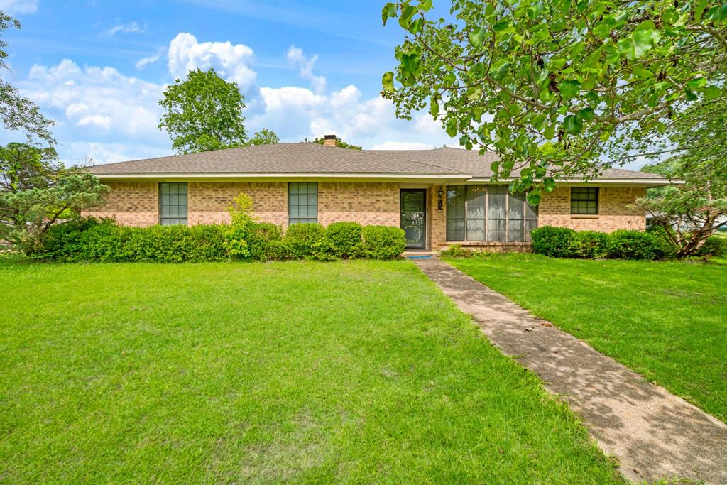 Welcome to this spacious and well-maintained 3-bedroom, 2-bathroom home situated on a generous 0.44-acre corner lot in the heart of Bogata, Texas. Offering a blend of comfort, character, and functionality, this property provides plenty of room both inside and out.

Step inside to discover a large living area featuring exposed wood beams, a cozy brick fireplace with wood-burning stove insert, and abundant space for gathering with family and friends. The adjoining dining area and kitchen offer ample cabinetry, extensive counter space, and a charming breakfast nook overlooking the front yard. The primary suite features a spacious layout with dual vanities and plenty of storage, while two additional bedrooms provide flexibility for family, guests, or a home office. A bright sunroom adds extra living space and creates the perfect spot for relaxing, hobbies, or entertaining year-round. Outside, you'll enjoy the oversized yard shaded by mature trees, a fenced backyard, a gazebo, storage building, and additional covered storage space. The corner lot provides extra privacy and curb appeal while still being conveniently located near local schools, shopping, and community amenities. Whether you're looking for your first home, a place to grow, or a peaceful retreat in Northeast Texas, this property offers endless potential and plenty of space to make it your own.