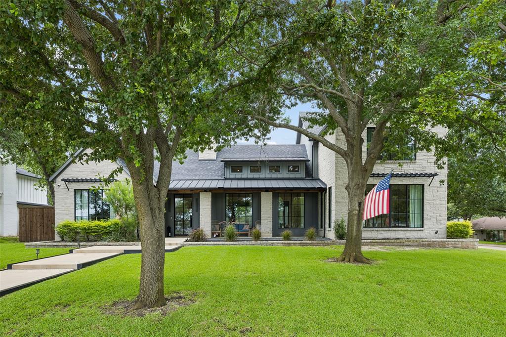 Built in 2021, this spectacular Modern Farmhouse blends contemporary design with timeless warmth, offering 5,382 square feet of high-end luxury. From the soaring high ceilings and Lutron lighting throughout to the striking black-frame windows that flood the home with natural light, no detail has been overlooked.  The ultimate Chef’s Kitchen is engineered for world-class entertaining, featuring premium Thermador appliances including a 6- burner gas range plus griddle, stainless steel dishwasher, built-in oversized refrigerator and an under-counter microwave. The oversized island also has seating for those casual dinners. Seamlessly transition from dinner to drinks with a dedicated wet bar featuring a built-in 48 bottle wine fridge and icemaker. Beautiful white oak wood flooring runs throughout most of the home. The living areas are open concept and don't miss the gas fireplace with glass rocks. The first floor primary retreat is a sanctuary all it's own complete with spa-like bathroom featuring a freestanding soaking tub, an oversized walk-in shower and honed granite countertops. All of the bedrooms have private baths and walk-in closets with built-in drawers. For all-season entertaining step outside to a large covered patio with remote controlled electric shades. The patio has built-in heaters as well as fans. A large, fenced backyard  completes the picture. Situated in the highly coveted Private School Corridor, this home delivers a combination of beautiful architecture and everyday functionality.