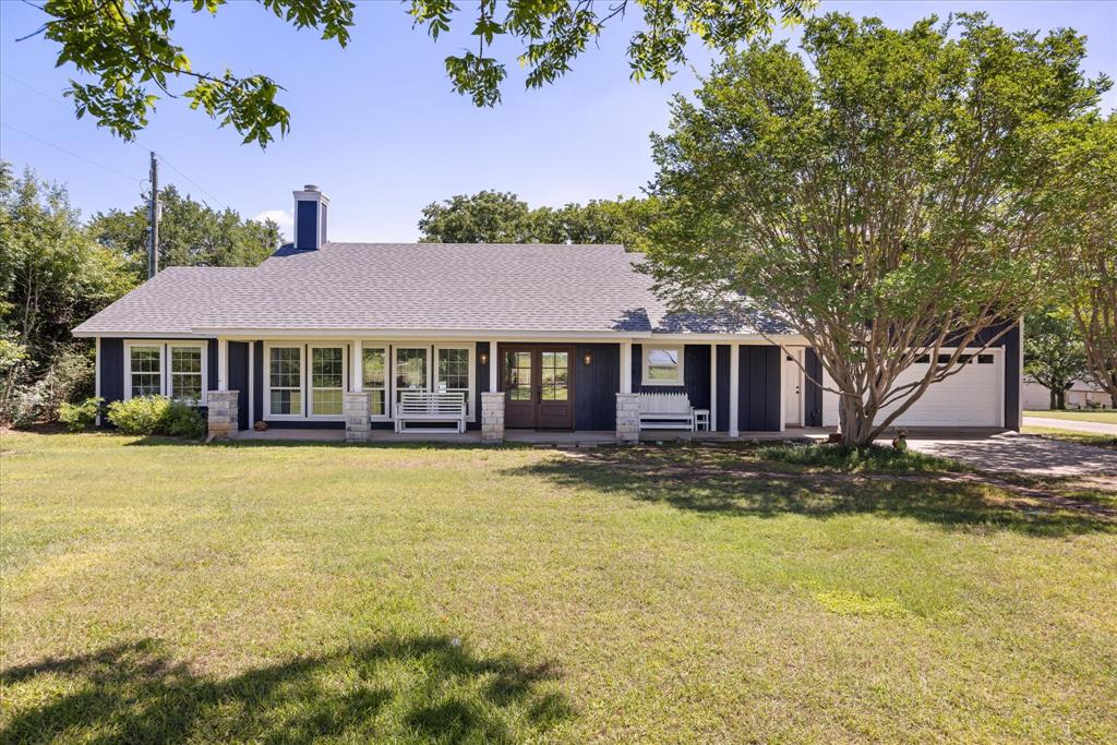 LAKE FRONT LAKE HOUSE on DEEP WATER!! Welcome to 3818 Mambrino Hwy located on the main body of Lake Granbury.  This 2387 total square foot modern farmhouse style home offers the perfect blend of family comfort and upscale sophistication. Spanning 1865 square feet, the main home features three spacious bedrooms and two full baths complemented by a cozy stone wood-burning fireplace with mesquite wood mantle. The master bedroom has a  large seating area with exquisite views of the lake. The completely remodeled kitchen features a large island, quartz countertops, pantry, double oven, copper vent hood and farmhouse sink, large drink cooler, and ample cabinet storage space. The kitchen extension offers a large sliding serving window to the back porch that makes entertaining a breeze.  Above the oversized, two car garage is a beautifully remodeled one-bedroom, one-bath apartment (522 square feet) with a family room and wet bar. This retreat with its own private entrance and mailbox, provides opportunities for guests, multi-generational living or VRBO potential; all with lovely views of the lake. Step outside and enjoy breathtaking lake views on the expansive back porch (13.5 x 33 feet) perfect for entertaining. The porch was built with reinforcements on the north end for a future fireplace addition. The backyard is fenced and includes a storage shed.  A tram effortlessly carries you to a 30 x 30 ft. dock with storage shed, sitting area, expansive lake views, pontoon boat lift and lake pump. This home has been meticulously updated including a completely remodeled kitchen, master bedroom, kitchen and family room expansion, new exterior and interior paint (2023), updated bathrooms, new windows (2021), new window coverings including black out shades in all bedrooms (2023 & 2026), new LVP flooring (2023 & 2026), carpet (2022 & 2026), and shiplap accented ceilings and walls. The roof was replaced in 2023. This is a rare find!