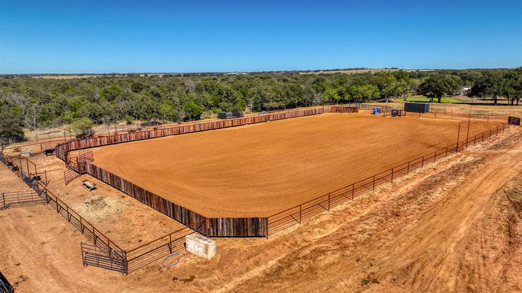 This property carries undeniable value with its easily accessible location just off US Hwy 281. Set on 48.5 acres, the drive through the property takes you past a fully stocked pond and peaceful hunting area, often home to grazing deer, before arriving at the beautiful Austin Stone residence and professionally designed training complex.

The facility is thoughtfully designed for flexibility and functionality, featuring 35 large stalls that can be easily divided into up to 80 smaller stalls, allowing the layout to adapt to a variety of operational needs. Additional improvements include six covered turnout runs, four fully fenced pastures, a covered round pen with premium footing, a 150’x250’ roping arena, five pipe cattle pens (two with automatic waterers), three 50-amp RV hookups, a dedicated shavings storage barn, gated entrance, and more.

Constructed in 2024, the main barn offers a 3-horse wash bay, LED lighting throughout, and a beautifully finished programmable 6-horse Priefert panel walker. A dedicated 30’x80’ equipment storage barn provides ample space for trailers, tractors, and operational equipment. The second barn includes 10 additional stalls with a concrete alley, wash bay, and six covered runs, making it ideal for show horses, mares, or yearlings, with convenient access to the roping arena and cattle pens.

Follow the long, scenic drive to the secluded 2,700+ square foot residence, offering a comfortable retreat after full days around the facilities. The home features four bedrooms, three and a half baths, an oversized two-car garage, granite countertops, a spacious kitchen island, gas stove, versatile office or dining space, and a cozy rock fireplace. Step outside to the covered back patio, wired for an outdoor TV, and enjoy views of tree-lined pastures and a rock fire pit — the perfect setting to unwind or entertain.