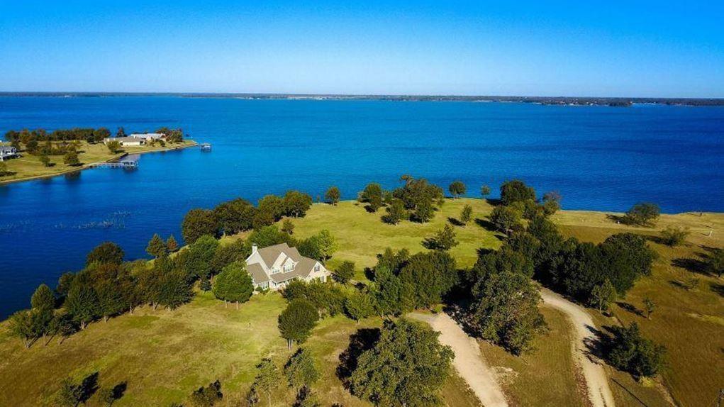 RARE LAKE FRONT ESTATE on 138+ acres situated on approximately 1500+ feet of Richland-Chambers Lake frontage. Whether you are into boating, fishing, hunting, horses, cattle, or just enjoying lake life this recreational paradise has it all.   Breathtaking panoramic water views from this custom-built home with Texas-sized rooms.  Features: Lg open family room, formal dining, stone fireplace, gourmet kitchen, Lg covered porch.  Approximately 1200 ft of steel retaining wall with a dock and boat ramp. 
Lots of Possibilities here! FANTASTIC PRIME AREA for DEVELOPING a lakeside community! The serenity of this lake estate is captivating with endless potential! Underground utilities have been run to 7 additional lake-front lots for possible future development.  Currently Ag Exempt (excluding 1-acre for home)*