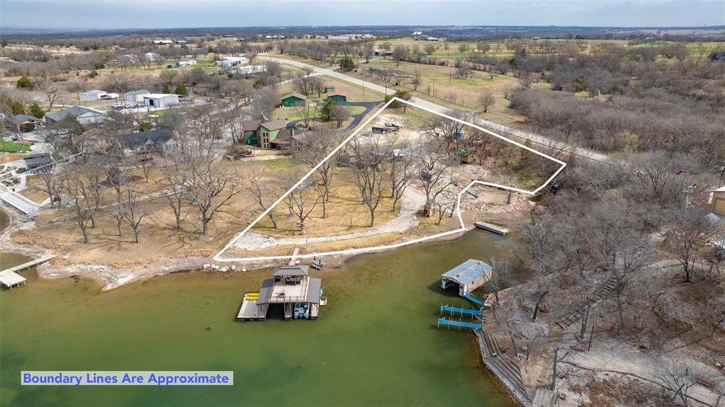 9102 Fm 1201 - Moss Lake Waterfront Retreat.  Experience the best of the lake lving on this stunning 1.46 - acre waterfront property with over 400 feet of shoreline on BEAUTIFUL Moss Lake. This 3 bedroom, 2-bath home offers the perfect blend of privacy, views and recreation. Private water well. Step outside to a true outdoor paradise featuring a two-story boat dock with two boat slips, a dedicated swim dock and an expansive upper deck- the ideal spot to unwind and take in those Moss Lake Sunsets. The property showcases a park-like setting with mature Pecan Trees, wide open green space, and breathtaking water views from your back porch.  Whether you're enjoying quite mornings with coffee or hosting family and friends for a lake weekend, this setting delivers. A unique modified Silo - adding character and functionality to this one-of-a-kind property. If you're looking for exceptional waterfront with space, views, and versatility, this Moss Lake gem is ready to welcome you home.