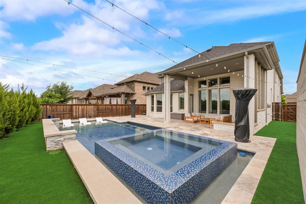 This exceptional luxury home tucked within the gated section of Auburn Hills is a must-see for those who are seeking that WOW factor! As you drive up, impressive curb appeal and manicured landscaping invite you into an elegant interior featuring 4 bedrooms, a private study, 4.5 bathrooms, 2 dining areas, massive game room, custom oversized metal front door, hardwood floors, and speakers throughout. The chef’s kitchen is the heart of the home, featuring a large island, beautiful custom-made cabinetry, stainless steel appliances, a coffee station, gas cooktop, double ovens, and a walk-in pantry. Expansive windows fill the home with natural light and offer views of the sparkling pool and outdoor living space, perfect for relaxing or hosting gatherings. A luxurious primary retreat boasts a bay window, oversized closet, and a spa-inspired bath with quartz counters, dual vanities, frameless shower glass, soaring ceilings, stunning open-concept and that's just the inside. Stepping out into your incredible backyard oasis, you immediately get resort-style vacation vibe! This fully decked out backyard offers: pool, spa, extended covered back porch, outdoor kitchen, turf, surrounded by more top notch landscaping. This Solar powered home is located in a secure master-planned community with a great variety of amenities, such as community pool, lake, trails, playgrounds, and scenic greenbelts. This property blends elegance, comfort, and convenience in one of the area’s most sought-after neighborhoods zoned in the highly sought-acclaimed McKinney ISD. Conveniently located just minutes from main highways, high-end shopping, fine dining, and major DFW thoroughfares.