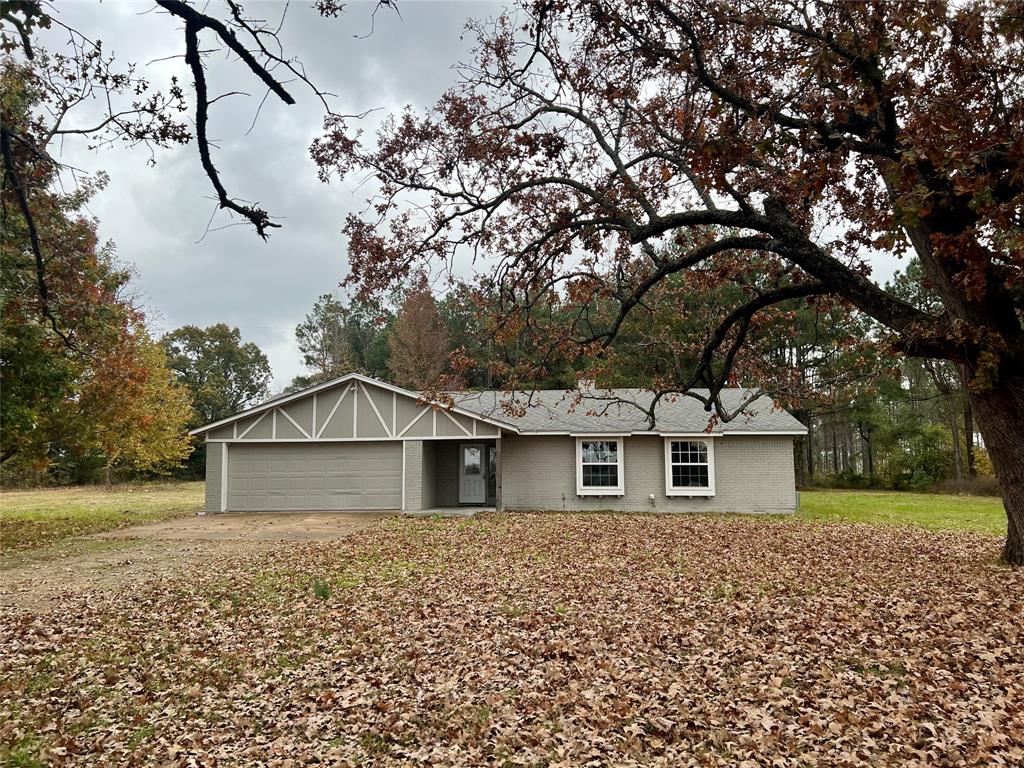 Professional photos coming 11.28.2023 - Beautiful, updated home in NLISD with Blossom, Texas address. Close to Paris, on paved County Road, you will appreciate the drive-up appeal. There are 2 full acres and recent survey. Front part of property where the home is located is open with a few trees, behind home is heavily wooded with beautiful mature Pine trees.  Home was reno'd in 2021 with new flooring, cabinets, counters, fixtures etc. Great upgrades throughout include coffee bar, huge pantry, island, countertops and fixtures, built in shelving. This home has 3 spacious bedrooms, walk in closets, climate-controlled sunroom and more. Schedule your tour soon.