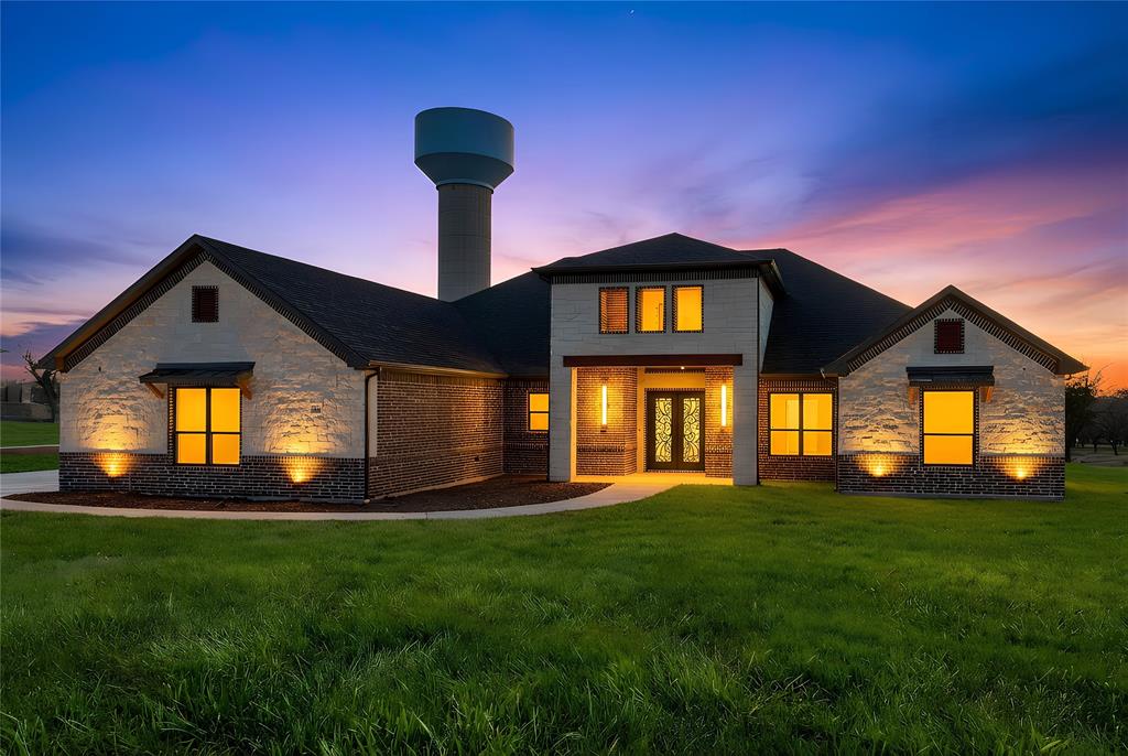 This exceptional 4-bedroom, 3.5-bath luxury modern farmhouse offers refined design, high-end finishes, and effortless indoor–outdoor living—all set within an exclusive gated community featuring a championship golf course, elegant clubhouse, and resort-style pool.

A bright, open layout welcomes you with expansive windows, clean architectural lines, and beautiful tile flooring throughout the main living areas. The spacious great room centers around a designer fireplace and flows seamlessly into the gourmet kitchen, creating an inviting space ideal for both daily living and entertaining.

The chef’s kitchen features gas-powered cooking, premium appliances, custom cabinetry, an oversized island, and a large walk-in pantry offering abundant storage. Just beyond, the impressive outdoor kitchen extends your entertaining options, perfect for gatherings, weekend grilling, or quiet evenings under the covered patio.

The luxurious primary suite provides a private retreat with a spa-inspired bath, freestanding soaking tub, dual vanities, and a generous walk-in closet. Three additional bedrooms offer comfort and flexibility for guests, family, or office needs, while 3.5 well-appointed baths ensure convenience for all.

Enjoy efficient gas heating, thoughtfully designed outdoor living spaces, and beautifully maintained surroundings. Residents benefit from secure gated entry and access to top-tier amenities including the golf course, clubhouse, and pool—creating a lifestyle that blends luxury, recreation, and modern comfort.

A truly remarkable home in one of the area’s most desirable communities.