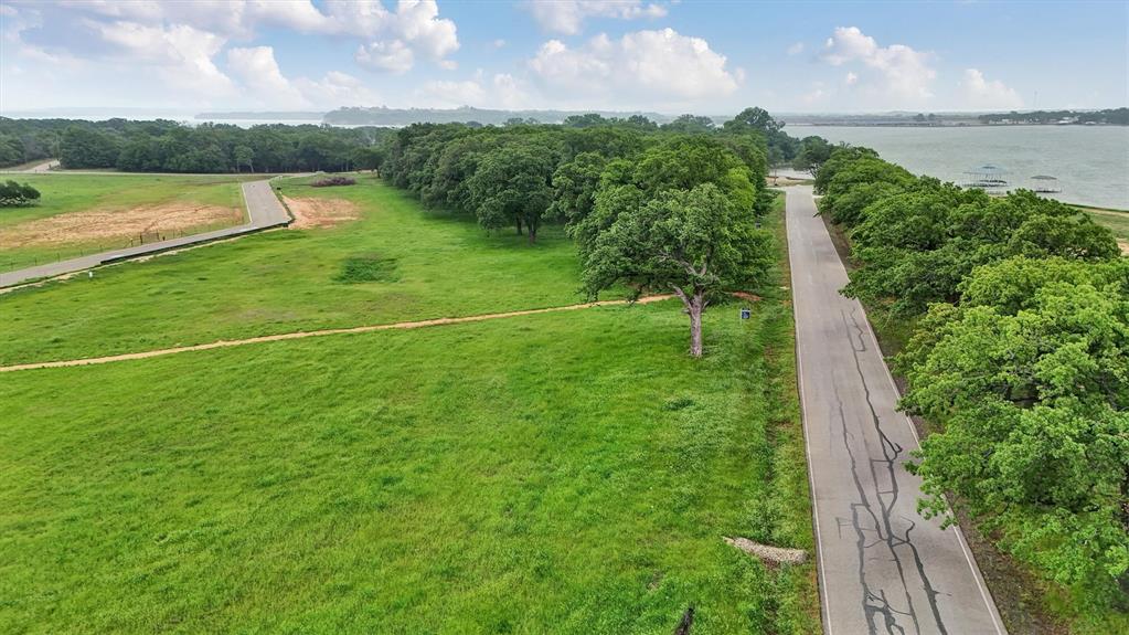 Discover Lot 15 at Waterfront on Park — a rare 1.00-acre homesite in an exclusive community on the tranquil, south-facing shores of Eagle Mountain Lake. Once a beloved city park, this private enclave now features just 16 premium lots with direct lake access for swimming, boating, and fishing, and breathtaking water views. Enjoy the serenity of lakeside living just minutes from vibrant downtown Fort Worth. This is your opportunity to create a custom retreat in a setting where nature, privacy, and convenience converge.