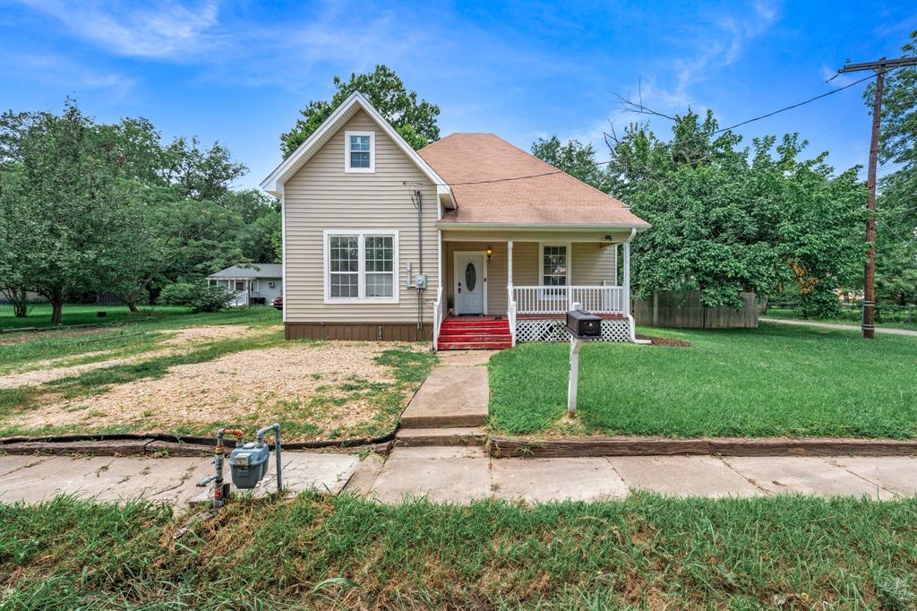 Step into the charm of this beautifully maintained 1910 home where timeless character meets everyday comfort. Nestled on an oversized corner lot in the heart of Commerce, this 3-bedroom, 2-bath home offers over 1,500 square feet of living space surrounded by mature shade trees and a spacious fenced backyard perfect for entertaining, relaxing, or play.
Inside, you'll immediately appreciate the soaring ceilings, oversized living room, original hardwood floors, and architectural details that give this home its warm, inviting feel. The spacious dining room creates the perfect gathering space while the bright kitchen offers ample cabinetry and plenty of room to cook and entertain.
The flexible floor plan features generously sized bedrooms, two full bathrooms, and a dedicated laundry room for added convenience. Outside, enjoy both a welcoming covered front porch and a large back deck overlooking the shaded backyard complete with a storage building, playset, and plenty of green space.
Conveniently located just minutes from Texas A&M University-Commerce, downtown shopping, restaurants, schools, and city parks, this home offers the perfect blend of historic charm, functional living, and outdoor space that's becoming increasingly hard to find.
Whether you're searching for your next home or a great investment opportunity, this Commerce gem is one you won't want to miss!