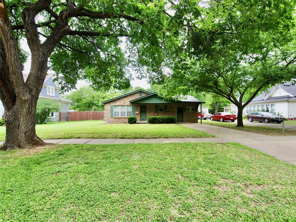 EXCELLENT WATER WELL for watering the lovely yard! This charming brick home near schools offers 3 bedrooms plus a BONUS ROOM or home office, 2 living areas, 1 bathroom and a 2 car metal carport in the backyard near the alley. Instant, on-demand water heater is powered by natural gas.  New natural gas line was installed two years ago underneath the house and also from the house to the alley.  New dishwasher.  New plumbing underneath sinks.  Main house has a pier & beam foundation while the second living area is concrete slab as it was once a garage. Original hardwood floors in the bedrooms.  Carpet in the formal living room.  Laminate flooring in the second living area.  The kitchen offers an electric range, double stainless steel sink, garbage disposal, new dishwasher, refrigerator-condition unknown, and a washing machine which conveys to the buyer.  The dryer in the separate laundry area also conveys to the buyer. Central heat & air. New digital thermostat. Ceiling fans in most rooms. Small workshop or storage room with electricity. Separate covered area for lawn equipment. Covered wooden deck for sitting outside and relaxing. Gorgeous shade trees and large bushes provide privacy, along with a wood privacy fence on one side and a chain link fence on the other. Open gravel alley access into the backyard for your extra vehicles, trailers, RV, boat or jet skis. Featuring approximately 1,440 square feet of living area, a great WATER WELL and low property taxes this home can't be beat! Being sold as-is. Make plans to see this darling home while it is still available.