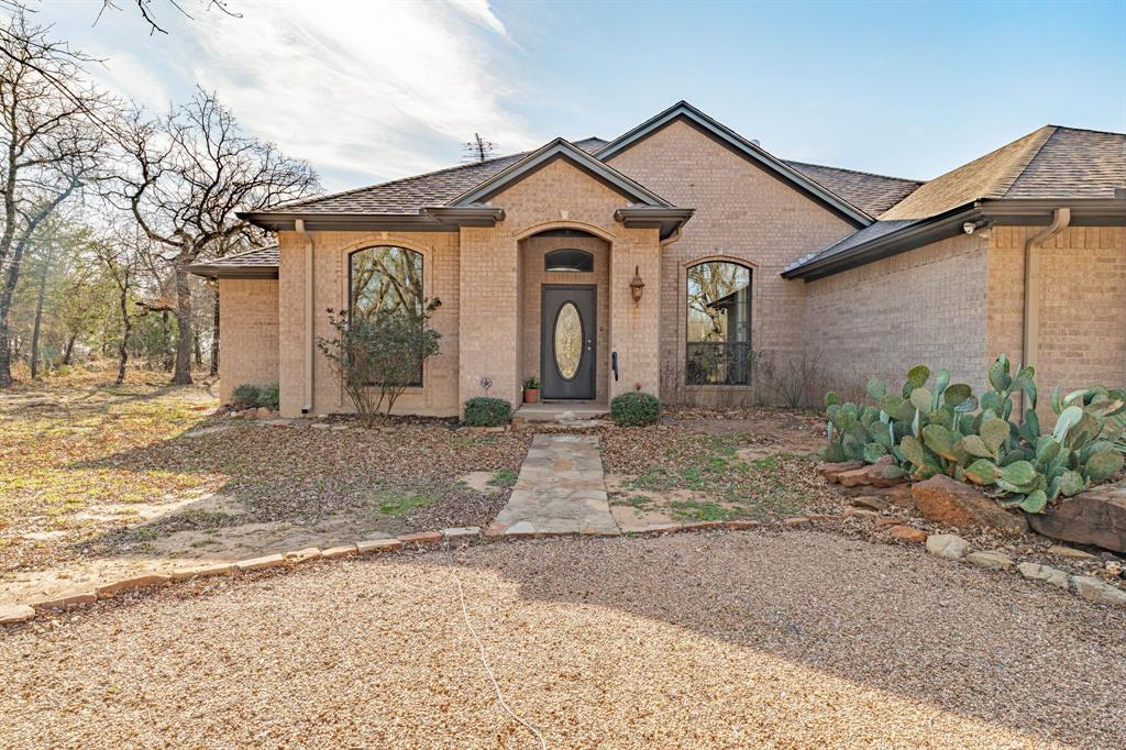 Welcome to your perfect lake retreat in Gordon, Texas! Just a short walk to the boat ramp and the scenic shores of Lake Palo Pinto, this beautiful brick home offers comfort, space, and the relaxed lifestyle lake lovers dream about.

Step inside to a spacious open-concept layout designed for gathering with family and friends. The home features three bathrooms and generously sized bedrooms, providing plenty of room for everyone to relax. The kitchen flows effortlessly into the living and dining areas and includes a charming breakfast nook and bar seating, the perfect spot to enjoy morning coffee or visit with guests while meals are prepared.

Outside, the property truly shines. The large, beautifully maintained yard is filled with mature hardwood trees, offering shade, privacy, and a peaceful country feel. Take a stroll out to the deck, where you can see the lake and soak in the stunning views, a perfect place for evening sunsets or weekend entertaining. The wildlife never goes unseen here, deer, birds and turkey like to visit. 

This property also includes a motorhome carport and boat carport, making it ideal for those who love lake life and outdoor adventure.

Whether you're looking for a full-time family home, weekend getaway, or vacation property, this location has it all. Outdoor enthusiasts will love being just a short drive from Palo Pinto Mountains State Park, Texas’ newest state park offering hiking, wildlife viewing, and breathtaking scenery.