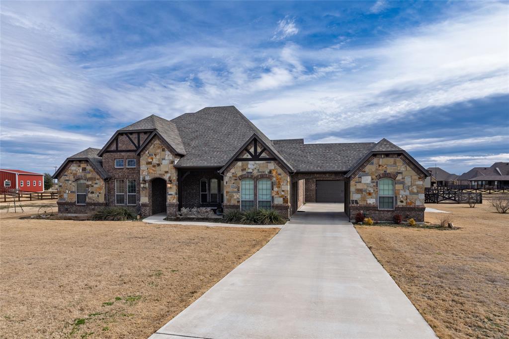 Situated on over an acre of land, this exceptional property offers space, style, and versatility both inside and out. From the moment you enter, you’re welcomed by soaring vaulted ceilings accented with stunning exposed wood beams, creating a warm and inviting atmosphere throughout the open layout. Designed for both everyday living and entertaining, the home features two expansive living areas that provide flexibility for gatherings, relaxation, or multi-generational living. A dedicated office offers the perfect work-from-home setup, delivering privacy without sacrificing convenience. The heart of the home flows seamlessly into the main living and dining spaces, highlighted by beautiful hand-scraped hardwood floors that add character and timeless appeal. Step outside to enjoy the large covered back patio—ideal for entertaining, grilling, or simply relaxing while taking in the wide-open space of your private acreage. For hobbyists, business owners, or anyone in need of extra workspace, the insulated workshop with electricity provides endless possibilities. Complete with a spacious three-car garage and room to roam, this property offers the perfect balance of comfort, function, and country-style living with modern conveniences.
