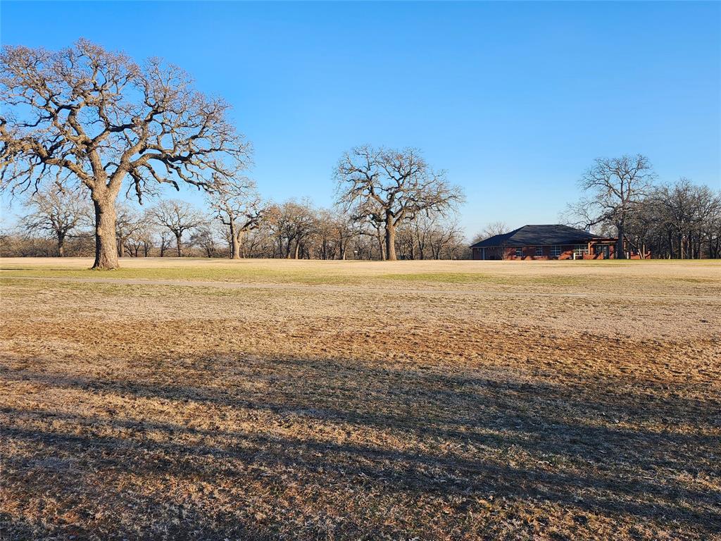 Golfers dream this beautiful build site backs up to hole number 17 on the golf course and has great views.  Property is 2 lots combined for a total of .58 of an acre. Mature oak trees give perfect amount of shade without blocking any views. lots are surrounded by the tranquility of nature as you will often see deer all around the property. Nocona Hills offers a 24-hour guarded gated community with access to two private lakes (one listed as top 5 Bass fishing in Texas)a community boat ramp and dock, as well as an 18-hole golf course with driving range, an airstrip, campgrounds with RV sites, and more. Utilities include co-op water and electric already at street. Fiber optic high speed internet is also available. Nearby surroundings include historic downtown Nocona, a winery, brewery and just a short drive to Saint Jo, Muenster and popular Casinos. Owner has multiple golf course lots available to choose from, please contact listing agent for details.  The Club house is under remodel along with the pool such an exciting new Update for the community.