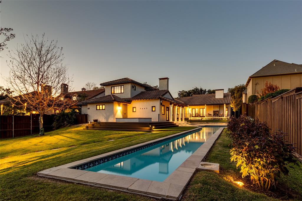 Situated on over half an acre, this stunning Mediterranean-inspired home is one of a kind. With a layout ideal for entertaining, enjoy a spacious living room with large fireplace. A wall of windows and doors let in natural light and open to a covered patio with fireplace, overlooking the expansive back yard. The gourmet kitchen features an oversized include, quartz countertops, stainless steel appliances including a built in refrigerator, two sinks and adjacent wet bar with ice maker. The primary bedroom is located at the end of the home and includes a gas fireplace and doors opening to a private sitting area. The ensuite bath includes an oversized shower and separate steam shower. Upstairs is a private study. Outside showcases a sprawling lawn, sparkling pool and spa, and greenhouse. Design details include Saltillo floor tile, hand painted tile work, Spanish-influenced decorative lighting, a cement tile roof and picturesque landscaping. Don’t miss this incredible Lakewood home!
