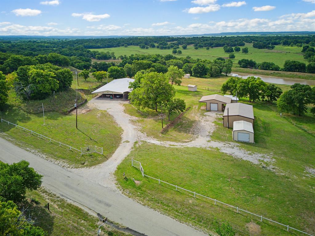 Country living at its finest with this oversized 3 bed 2 bath home built to last on almost 22 acres of land with a pond. The property is located in the quiet and beautiful Bonita area between Nocona and Saint Jo. With an open layout for the living, dining, and kitchen area, every room in the house is extra-large including the laundry and walk in closet. It boats spectacular views to the south overlooking a large bottomland owned by a much larger neighboring ranch. There are several outbuildings including an insulated workshop, insulated and functional equipment shop, boat storage building, large chicken coop, loafing shed, and RV carport. The mature trees have been groomed over the years to provide a more open understory. The property is fully fenced, ag exempt, and currently grazed by cattle with a small set of pens and working chute. Its location is great for wildlife with plenty of deer and pigs that frequent the property. With no pipelines or transmission lines, this clean property is encumbrance free. Don't miss your opportunity to escape the traffic and settle down in the tranquil environment of this turnkey property that is waiting for you to bring your equipment and animals.