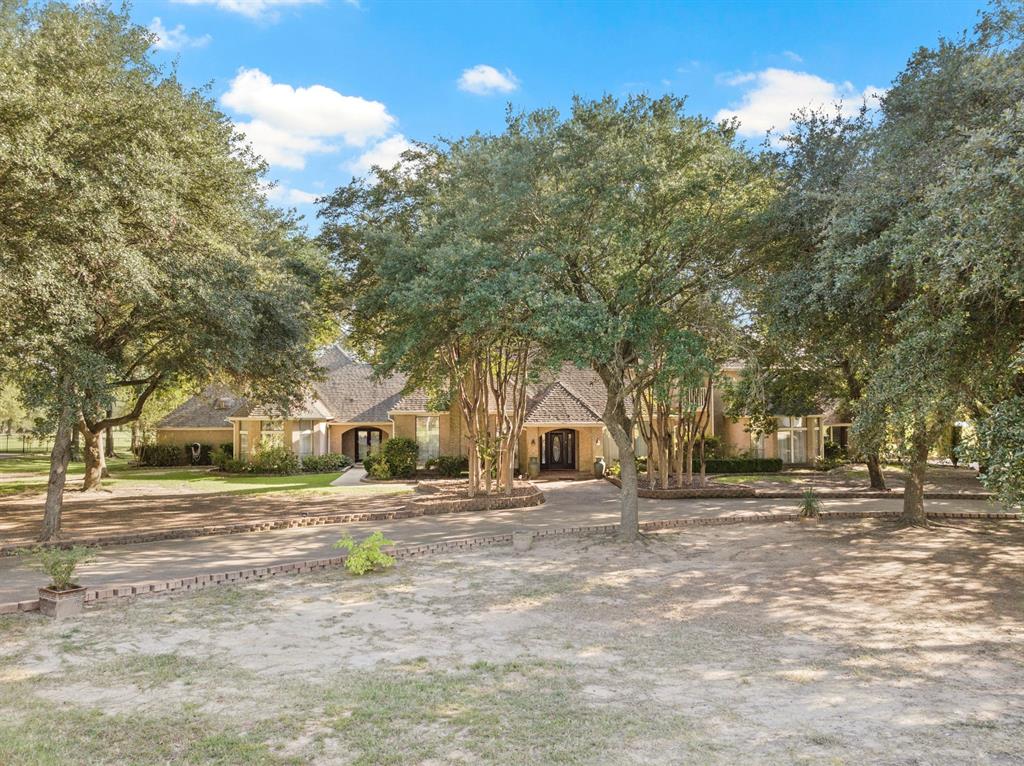 A true masterpiece in the Country Club Estates! This is a rare opportunity to own this custom built mansion on over 1.6 acres of golf front property! This prestigious home was built with timeless design! Boasting windows give you a view like no other of the rolling greens and lake! With a large open formal living room and dining room, wet bar and game room, entertaining family and friends will become your new hobby! The primary suite features a custom headboard, luxurious finishes throughout, a sitting area and a private patio overlooking the lush landscaped yard. Upstairs offers a 3rd living room with over sized bedrooms, each with doors opening to a private balcony! Call today for your private tour!