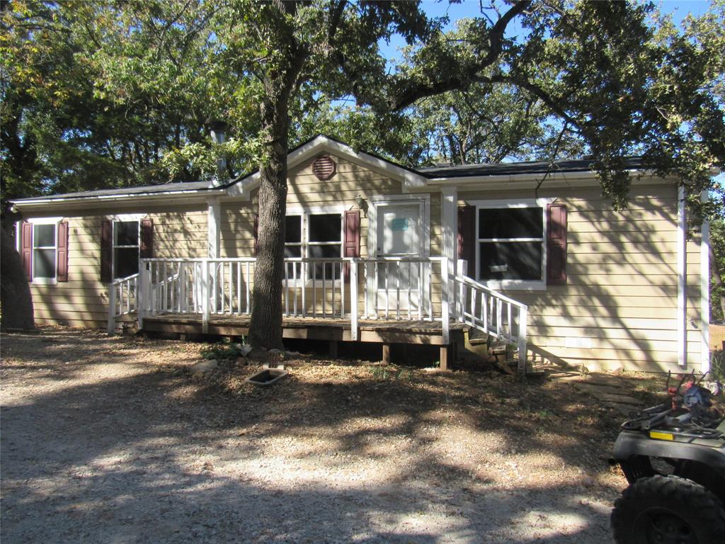 WHERE ELSE WILL YOU FIND A HOME THAT BACKS UP TO THE CORP OF ENGINEERS PROPERTY AND BEAUTIFUL LAKE TEXOMA AT THIS PRICE?  YOU SIMPLY WON'T! WALK THE PATHWAYS TO BEAUTIFUL LAKE TEXOMA SHORES FROM THIS VERY NICE DOUBLE WIDE AT THE EDGE OF CORP PROPERTY AND THE EDGE OF HI-LAND ACRES.  IF YOU ARE LOOKING FOR A LAKE HOME, VRBO, FULL OR PART TIME HOME, CHECK OUT THIS SMALL BUT WELL PLANNED HOME. FRONT AND BACK DECKS, BACK OF PROPERTY THAT ATTACHES TO CORP OF ENGINEERS LAND IS LINED WITH TREES,  NEW PRESSURE DRIP SYSTEM WAS JUST INSTALLED OCTOBER 2025 AND GROUND HAS NOT BEEN SEEDED OR SODDED AS YARD SINCE SYSTEM JUST COMPLETED MID OCTOBER.  MASTER SUITE ON OPPOSITE SIDE OF HOME THAN OTHER TWO BEDS AND BATH, BEAUTIFUL FRENCH DOORS ON KITCHEN TO OVERLOOK THE BACK OF THE PROPERTY AND PRICED BELOW GRAYSON COUNTY APPRAISAL NOTICE WITH A MOTIVATED SELLER. HIGHLY RANKED POTTSBORO SCHOOL DISTRICT, MINUTES TO SHOPPING, DINING, MEDICAL AND WITHIN 40 MIN OF FRISCO GOING SOUTH ON 289.  20 MIN TO DENISON, SHERMAN, WHITESBORO, DURANT AND EASY ACCESS TO ALL FROM THIS GREAT LOCATION AT THE LAKE! PLENTY OF ROOM TO BUILD A SHOP OR GARAGE, THIS IS A MUST SEE HOME!  BUYER TO VERIFY ALL.