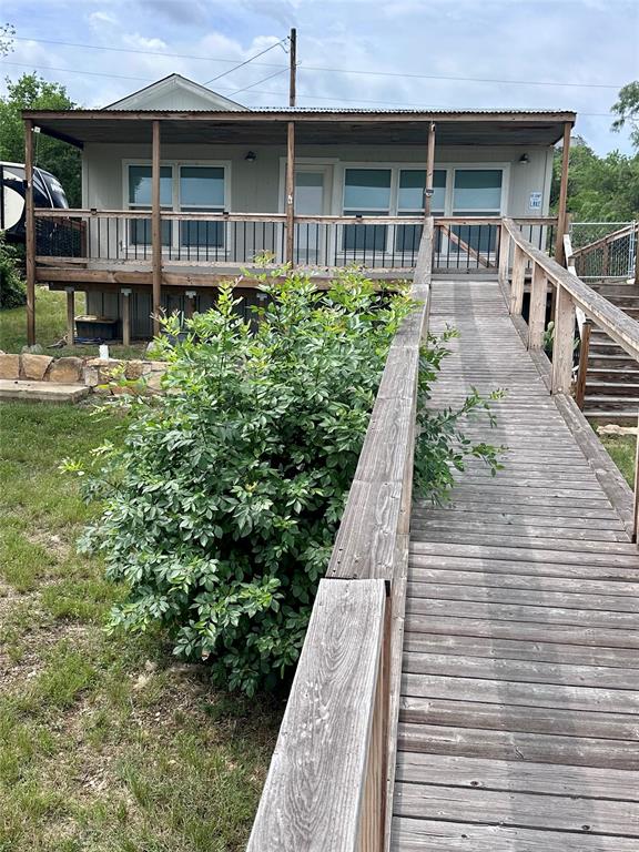 Escape to the perfect fishing getaway with this cozy one bedroom cabin, nestled on a highly sought after fishing lake. This cabin comes fully equipped with a king size bed and frame, a loft with mattress, washer, dryer, refrigerator and stove, making it ideal for weekend getaways or extended stays. Enjoy the convenience of water access with your own boat ramp plus it already has water and electric running along the walkway for easy access or adding a dock. You can spend your days casting a line or sit under the covered patio, do not miss this opportunity call for your showing.