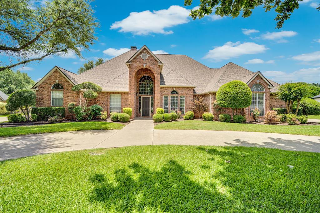 From the moment you arrive, the sweeping circle drive framed by magnificent mature trees sets the tone for the exceptional estate that awaits. Tucked in one of Waxahachie's most sought-after communities, this stunning 4-bedroom, 3 full and 2 half bath home offers nearly 4,000 sq ft of warm, character-filled living on 1.93 private acres with creek frontage. Oversized bedrooms provide generous space for the whole family, while two distinct living areas and two dining spaces give everyone room to gather, relax, and entertain. The chef's kitchen features white cabinetry, brick backsplash, and a center island flowing seamlessly into the main living area with soaring tray ceilings and walls of windows. A dedicated gameroom adds flexibility for fun and family life, and the oversized garage includes a walk-up attic perfect for storage or future expansion. Step outside where mature trees shade nearly two acres of lush grounds. Entertain on the covered patio with built-in grill, fireplace, and TV, then enjoy the sparkling pool, pickleball court with basketball goal, and a fully equipped detached pool house with custom gym and bath. Just minutes from downtown Waxahachie with the rare advantage of no city taxes — luxury, privacy, and savings all in one remarkable property. Don't miss this rare opportunity — schedule your private showing today.