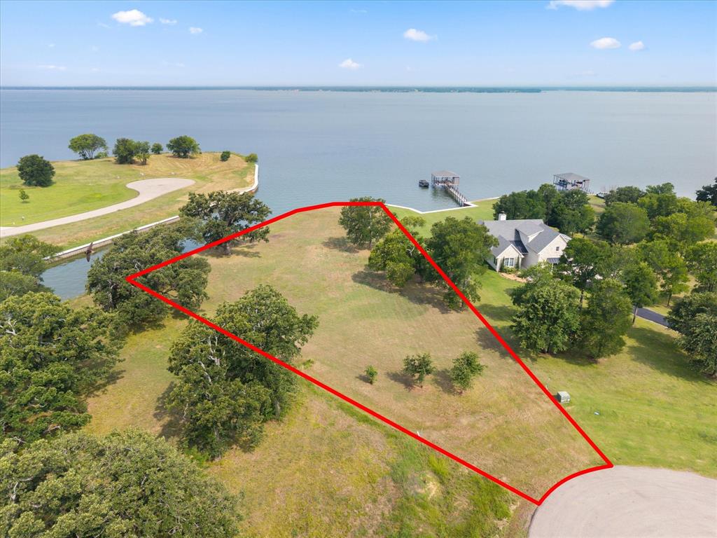 Build your dream lakefront home on Richland Chambers Lake, the third-largest lake in Texas. This exceptional 1.05-acre waterfront homesite offers approximately 300 feet of shoreline, protected by a steel retaining wall, providing both beauty and shoreline stability. Located in the desirable Admiral Shores subdivision on the south side of the lake, this property offers privacy, seclusion, and outstanding water access. Residents enjoy a gated entrance and a private boat ramp exclusively for property owners.Lot 11 is ideally situated in a cul-de-sac and features a few mature trees, creating a picturesque setting for your future home. The property enjoys waterfront frontage on both a protected cove and open water, offering the best of both worlds for boating, fishing, and lakeside living. Utilities, including water and electricity, are available at the road front of the property. The subdivision is restricted to site-built homes only, with no required timeframe to begin construction, allowing you to build at your own pace.  Come and view this unique property and make it yours!