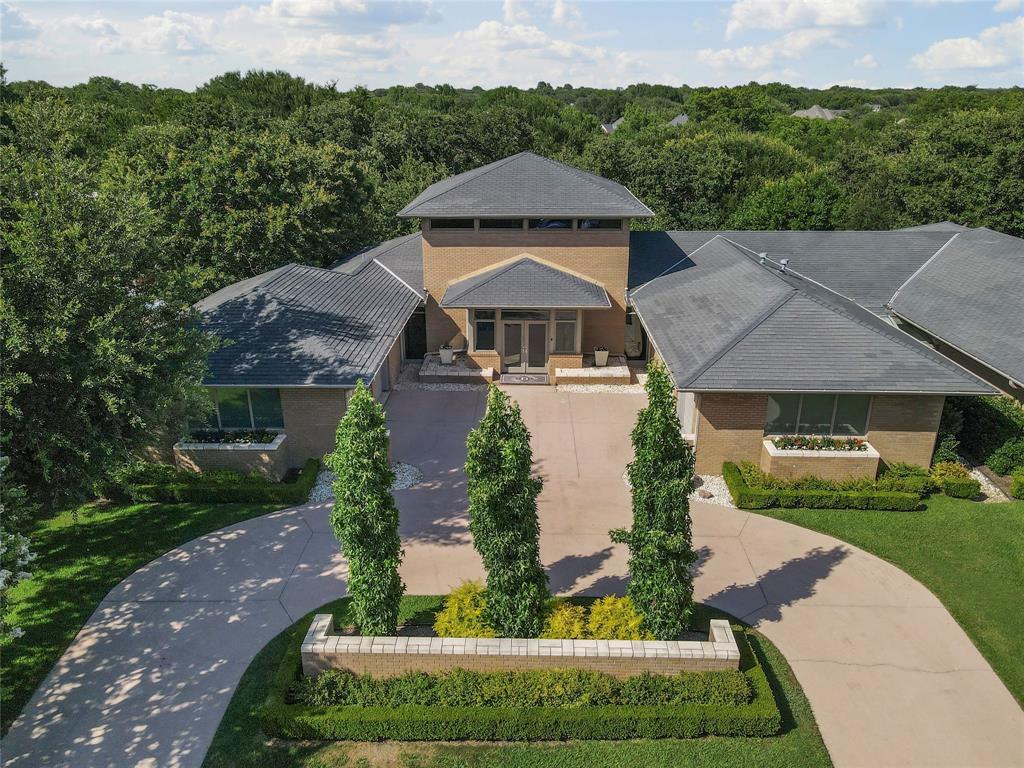 This is where they hide the light! This stunning contemporary home, designed by architect Nelson Hodges, echoes design by Frank Lloyd Wright with soaring ceilings, exceptional craftsmanship, and amazing light-filled rooms. Boasting 5 bedrooms each with an ensuite bath, a dedicated office, a chef inspired kitchen, up and downstairs utility rooms, tons of storage, two 2-car garages accessed through a beautiful courtyard and circle drive, a class IV roof, this home is built not only for elegant entertaining but a lifestyle second to none. It offers numerous balconies and private patios and a Claffey built pool. Monticello provides walking trails, ponds, tennis and more.