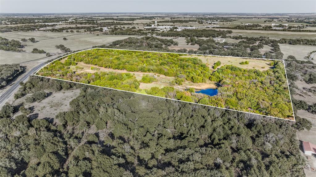 Breathtaking and private, heavily treed with wide open space on this expansive Wildlife Exempt 37+ acre lot in up and coming Pilot Point. Excellent location just minutes from Lake Ray Roberts and Isle Du Bois State Park and centrally located to Denton and Frisco. Amazing investment being on FM 455. Could be divided into 5 acre+ parcels. Great opportunity to build your own private oasis or keep for future development; the possibilities are endless!