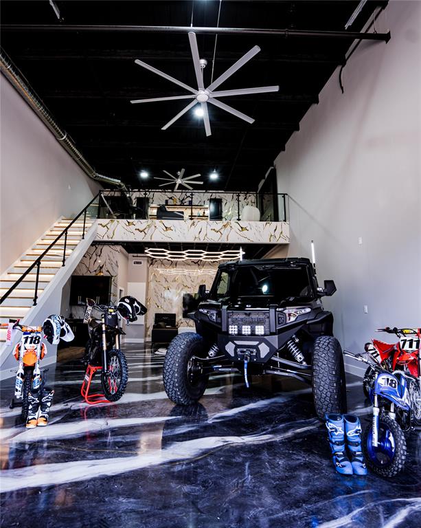 Experience the ultimate blend of luxury, functionality, and automotive lifestyle in this fully customized 1,602-square-foot loft-style garage. Located within an exclusive gated 3.5-acre development featuring just 63 privately owned suites, this exceptional unit has been thoughtfully upgraded to create a sophisticated retreat for collectors, entrepreneurs, and enthusiasts alike.
The expansive 25' x 50' floorplan showcases soaring ceilings, sleek epoxy flooring, and contemporary industrial architecture, while a custom-built mezzanine maximizes usable space and enhances the loft-inspired design. Premium finishes throughout include a private lounge with fireplace ideal for entertaining, a beautifully appointed custom bathroom, and a climate-controlled custom wine cellar that adds a refined touch rarely found in this unique asset class.
Designed to accommodate luxury vehicles, exotic car collections, recreational equipment, or a personalized showroom environment, the flexible open-concept layout easily adapts to a variety of uses. Whether serving as a private automotive gallery, executive office, showroom, or creative studio, the possibilities are virtually limitless.
Owners enjoy the security and convenience of gated access, along with the camaraderie of a vibrant community of like-minded collectors and professionals. Combining secure storage, luxury amenities, and exceptional versatility, this one-of-a-kind property offers a rare opportunity to own a truly distinctive lifestyle investment.