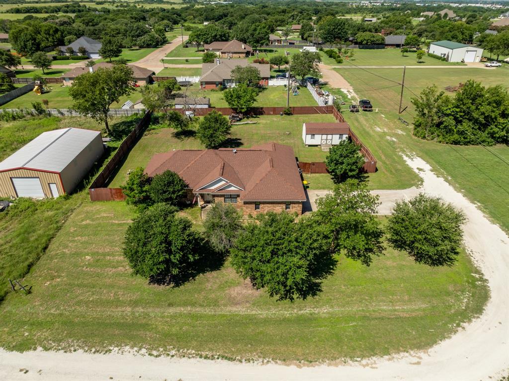 Just down a quiet private drive lies a rural getaway on a spacious lot outside of the city limits! Landscape to your hearts desire, grow a garden or just be at peace in your backyard away from all the hustle of bustle of the city without skimping on quick and easy access to shopping and restaurants! Solid brick home with 3-bed, 2-ba, 2 car garage, workshop, and privacy fence-all sitting on a half acre! Layout with great flow including 2 dining areas with one currently being used as a 4th bedroom. Primary bedroom is isolated for privacy and features a roomy ensuite bathroom with separate shower, jetted tub, dual sinks, and huge walk in closet. All bedrooms have walk in closets, great for the storage lovers! Outside features sprinkler system, scattered park like trees, and a privacy fenced backyard ready to create the perfect outdoor living oasis! Kitchen has all new appliances and pantry for storage. Roof replaced around 5 years ago. Less than 2 miles from highway I-35 makes this location ideal for commuters! Come see our Bucees and the new restaurants coming in off I-35!